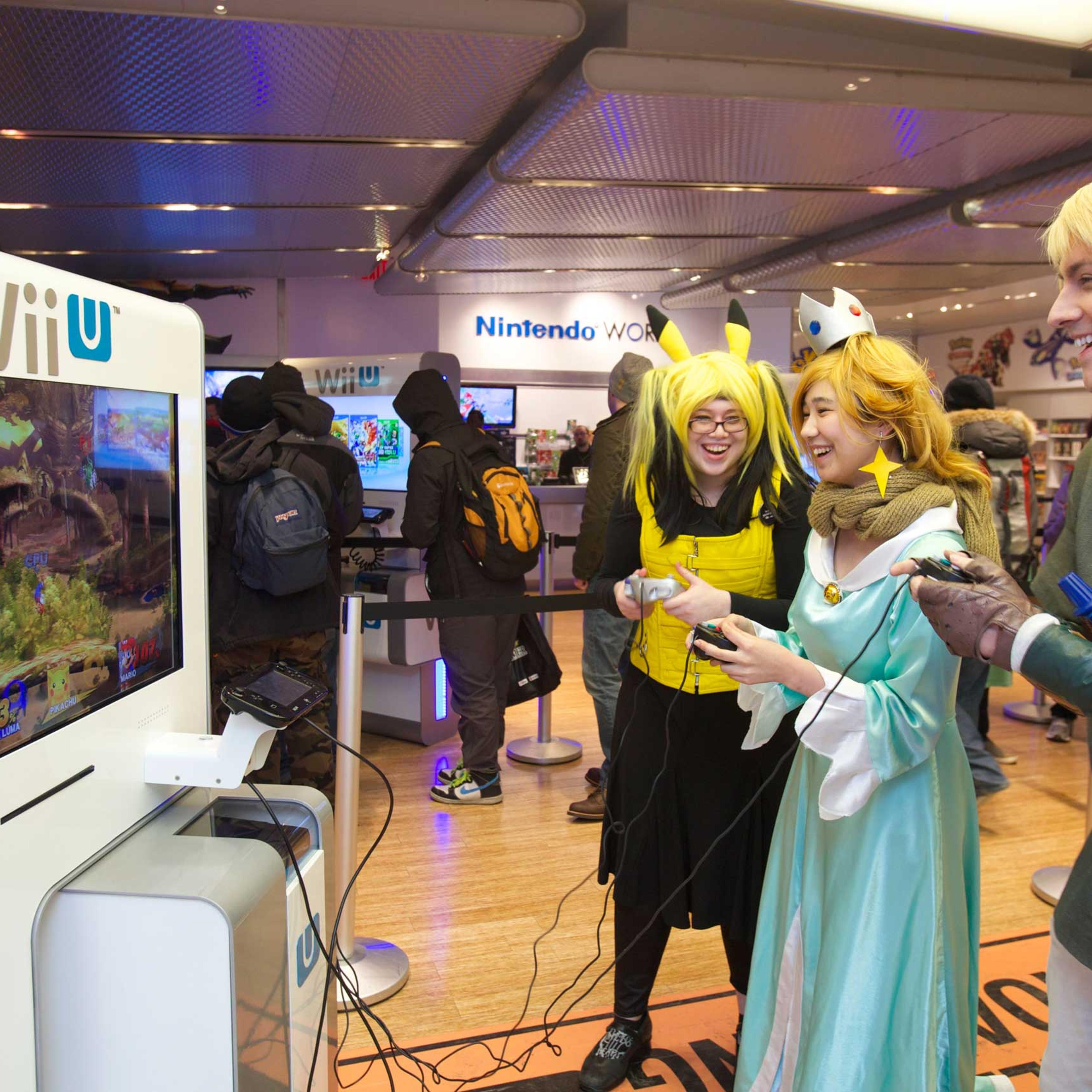 Left to Right: America, Elle M. Julia D., and Erich M. play the Super Smash Bros. for Wii U video game at the Nintendo World store launch event in New York on Nov. 20, 2014.