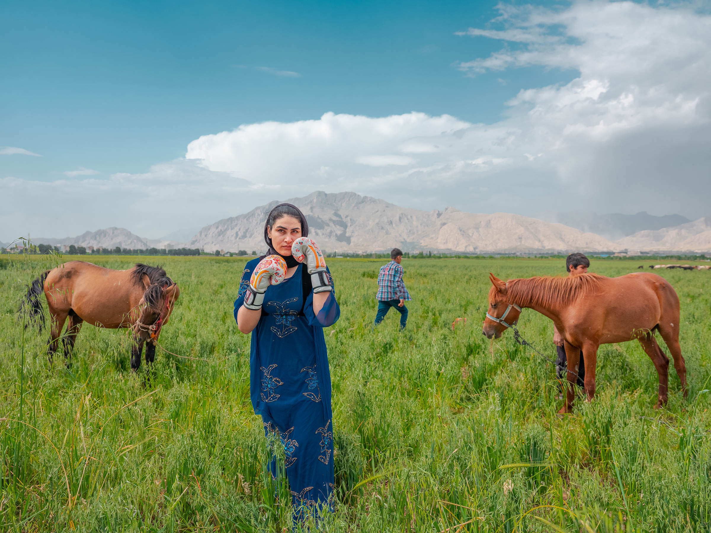 Sahar poses for a photo while wearing her boxing gloves in Kermanshah, western Iran on May 20, 2024. Born in 1992 in a nomad family, Sahar started secretly fighting as a Kungfu fighter in a sport club in Kermanshah city, the tribe's origin; while in a short time, she became fond of kickboxing. Sahar had dozens of championships in kickboxing and became a role-model for other girls of nomads. She is now in Iran's national team and is a trainer of a club in the city. 