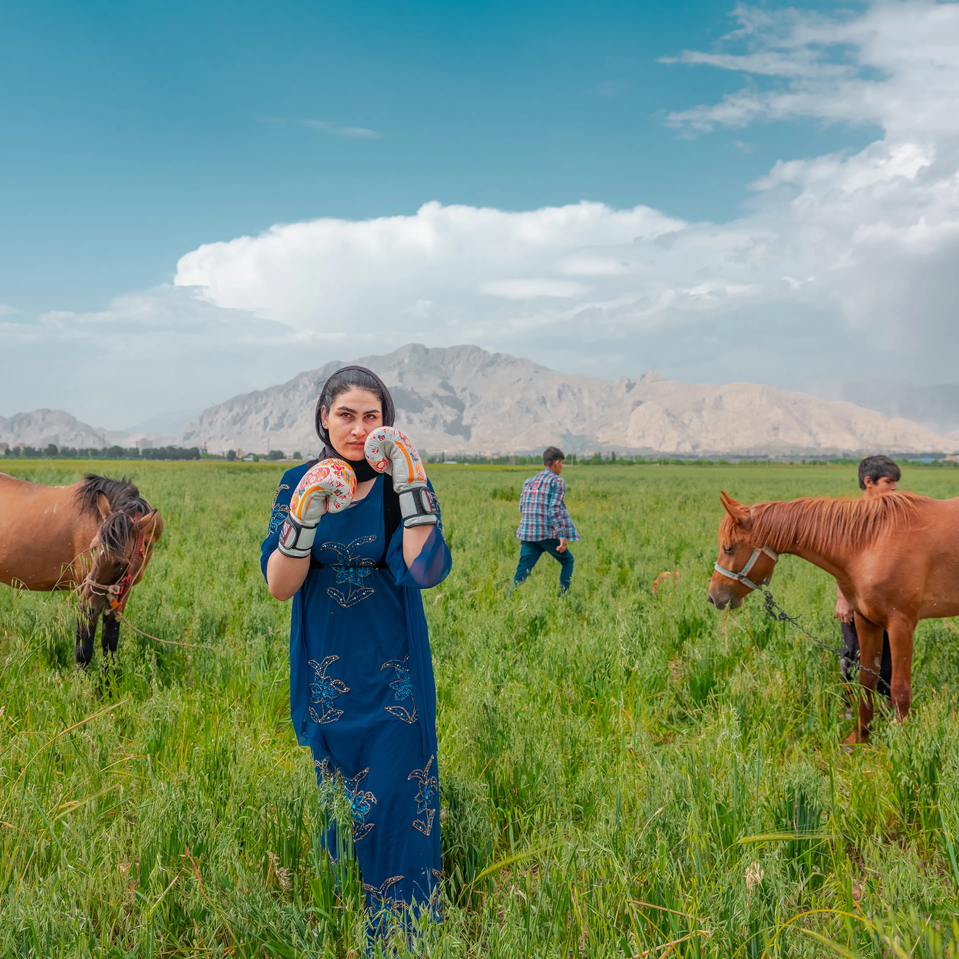 Sahar poses for a photo while wearing her boxing gloves in Kermanshah, western Iran on May 20, 2024. Born in 1992 in a nomad family, Sahar started secretly fighting as a Kungfu fighter in a sport club in Kermanshah city, the tribe's origin; while in a short time, she became fond of kickboxing. Sahar had dozens of championships in kickboxing and became a role-model for other girls of nomads. She is now in Iran's national team and is a trainer of a club in the city.