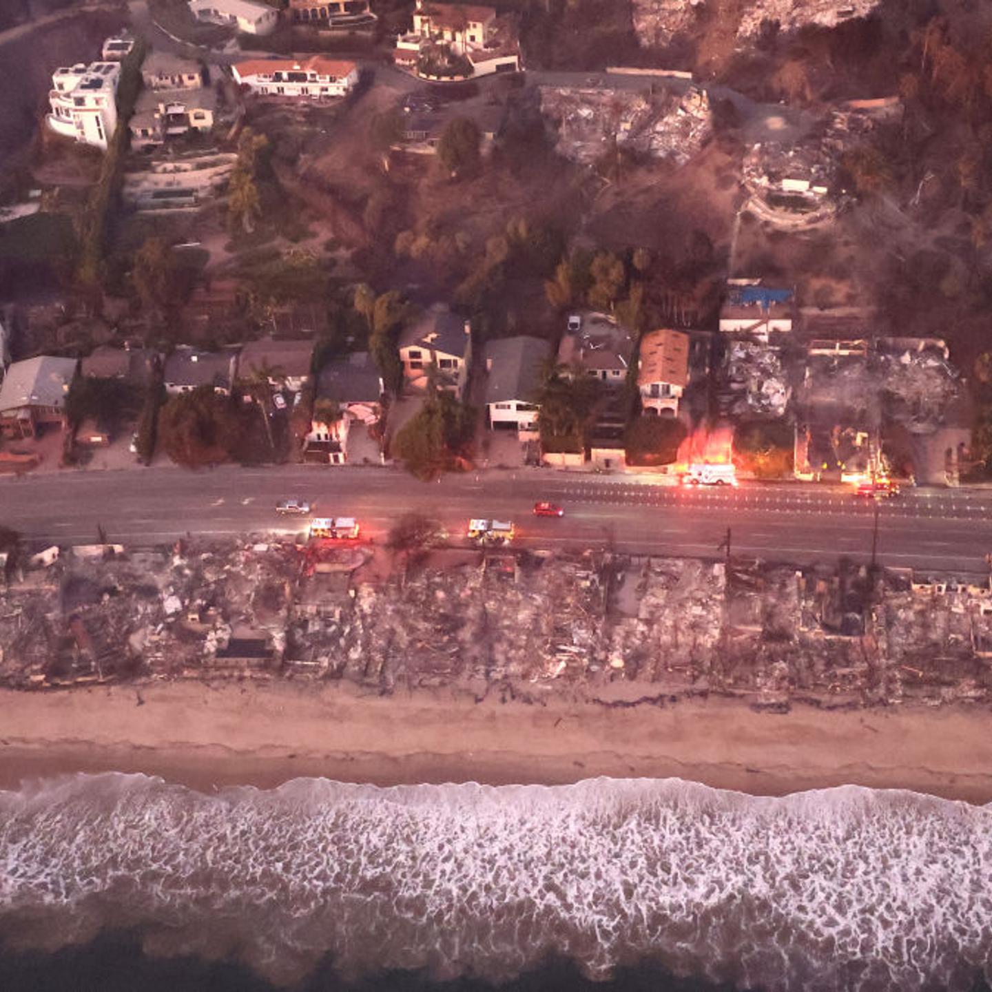 In an aerial view, destroyed homes are seen along the beach as the Palisades Fire continues to burn in Malibu, Calif. on Jan. 9, 2025.