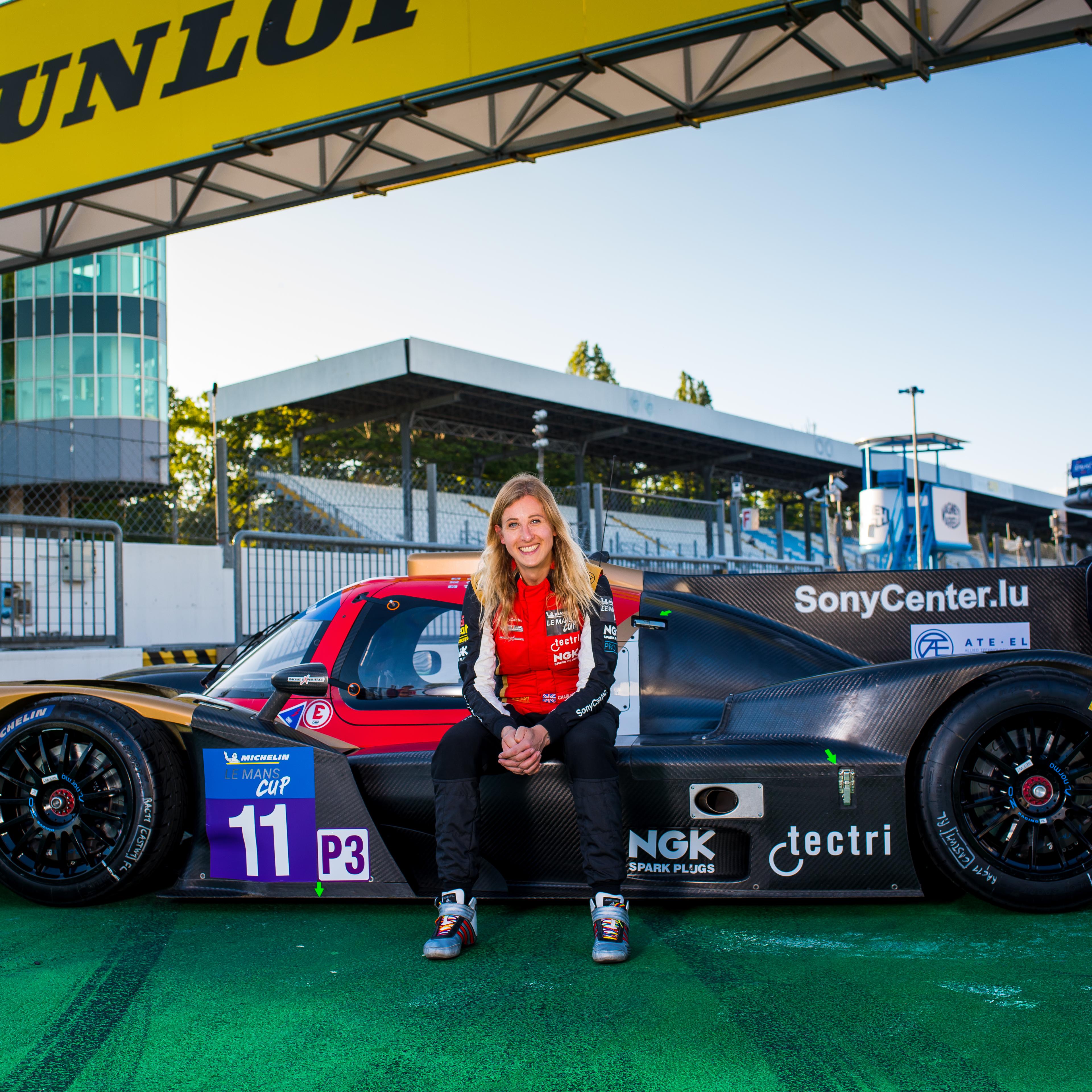 Charlie Martin with the LMP3 car that she'll be racing in the Michelin Le Mans Cup