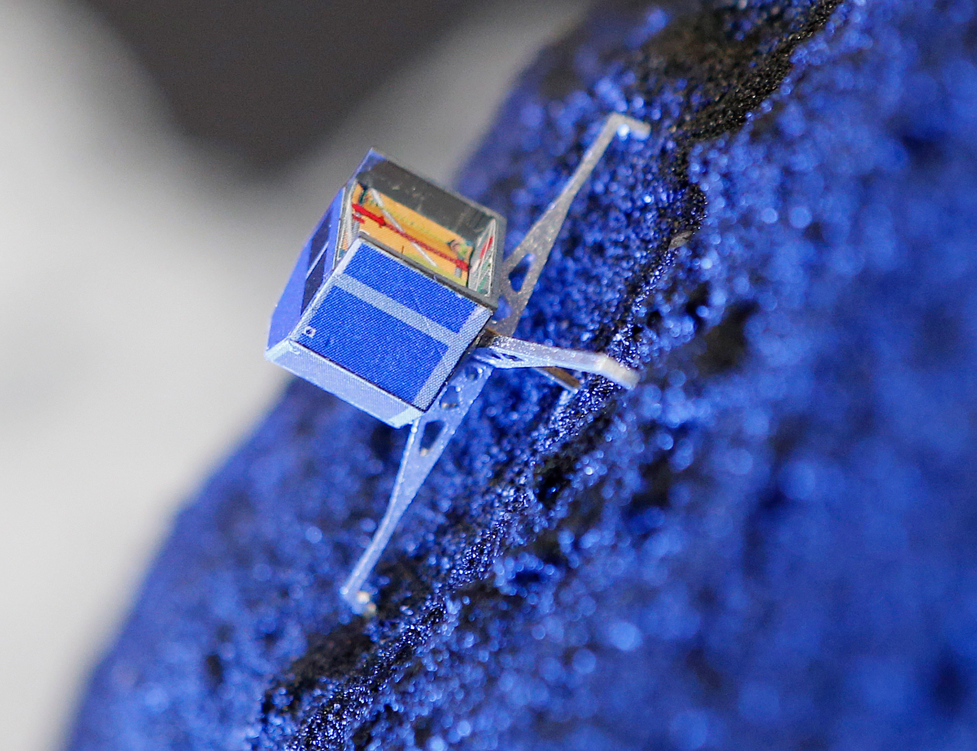FILE - In this Nov. 12, 2014 file photo a model of Rosetta lander Philae stands on a model of comet 67P/Churyumov-Gerasimenko, at the European Space Agency ESA in Darmstadt, Germany. European scientists said Friday Feb. 12, 2016 they have stopped sending