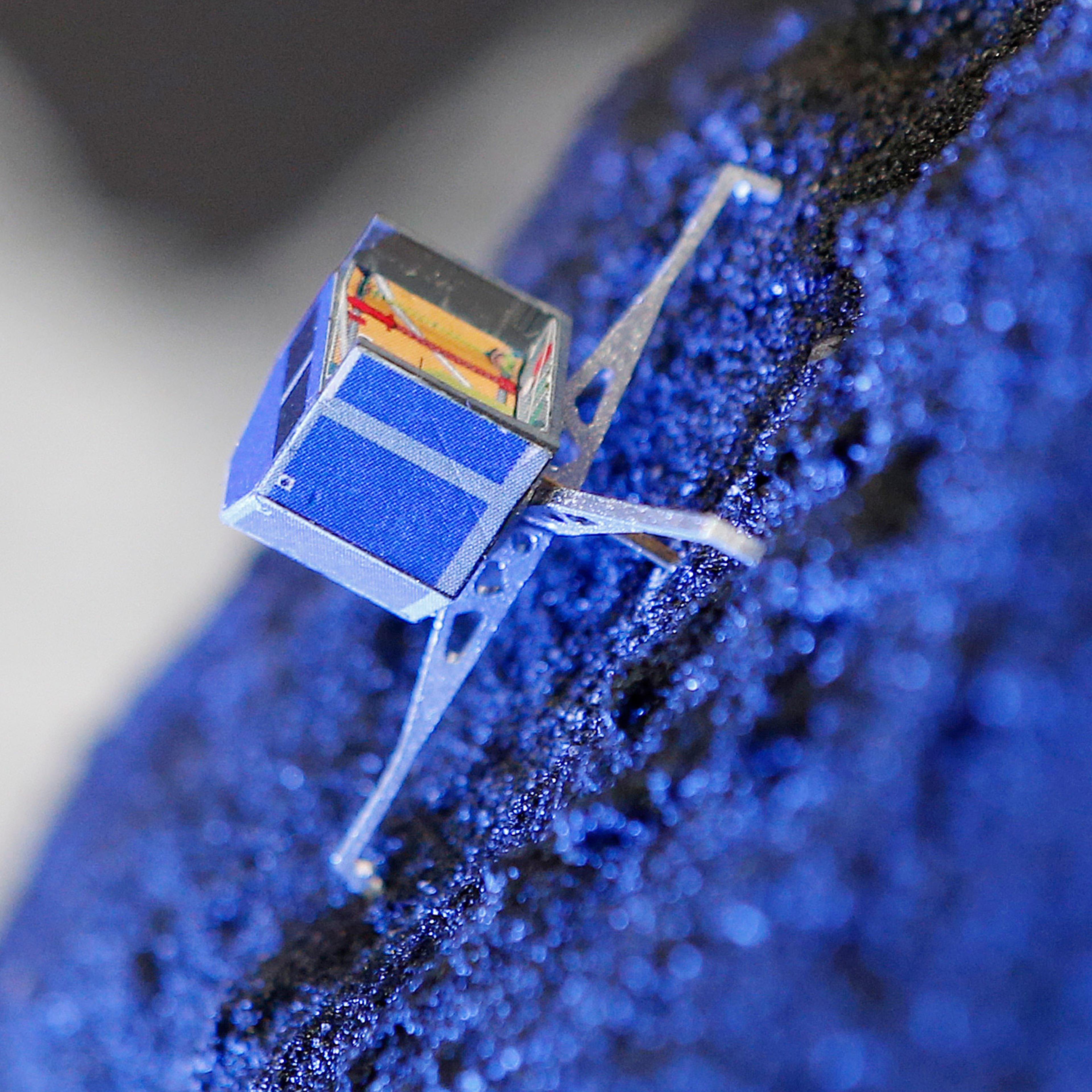 FILE - In this Nov. 12, 2014 file photo a model of Rosetta lander Philae stands on a model of comet 67P/Churyumov-Gerasimenko, at the European Space Agency ESA in Darmstadt, Germany. European scientists said Friday Feb. 12, 2016 they have stopped sending
