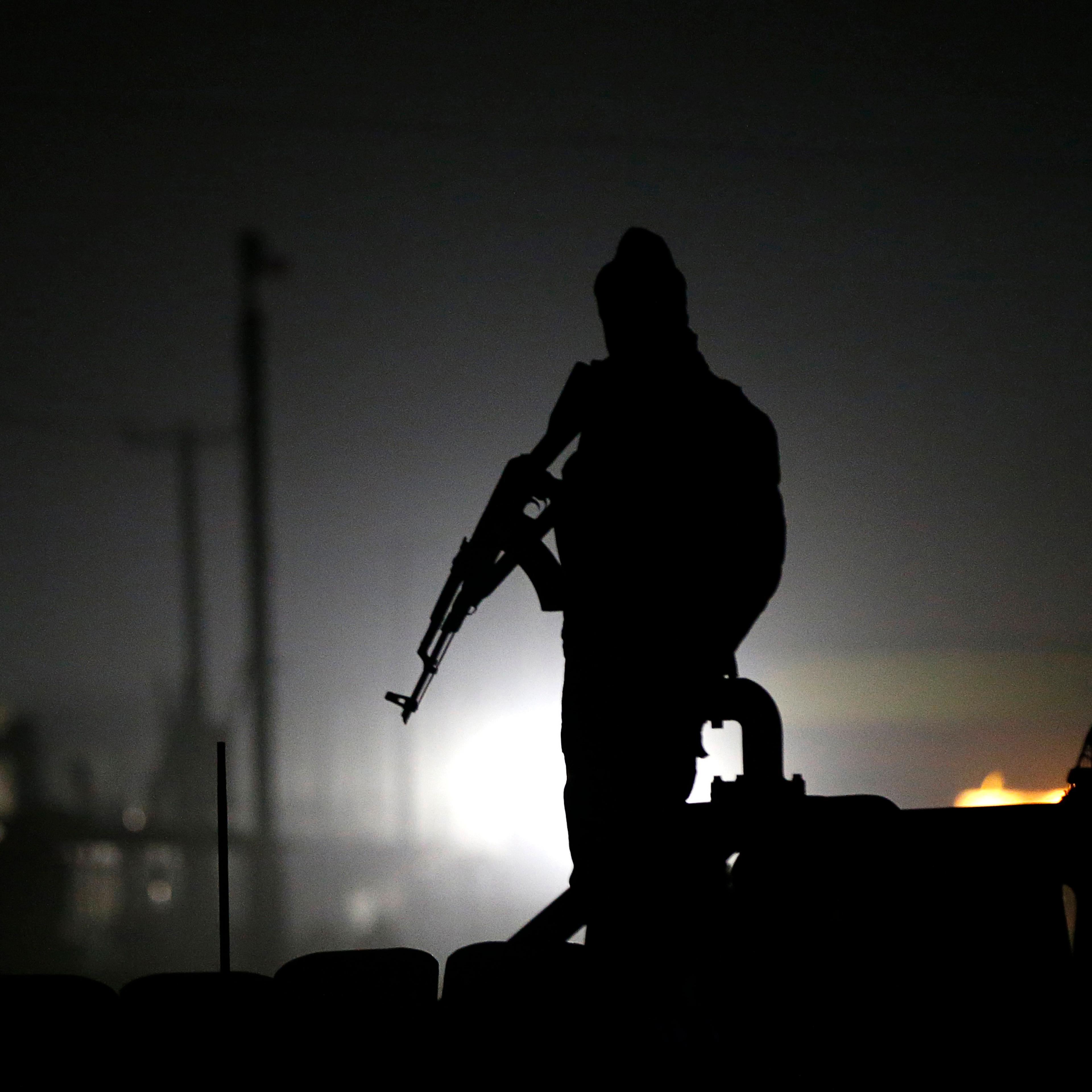 Afghan policeman keeps watch at the site of a Taliban attack in Kabul