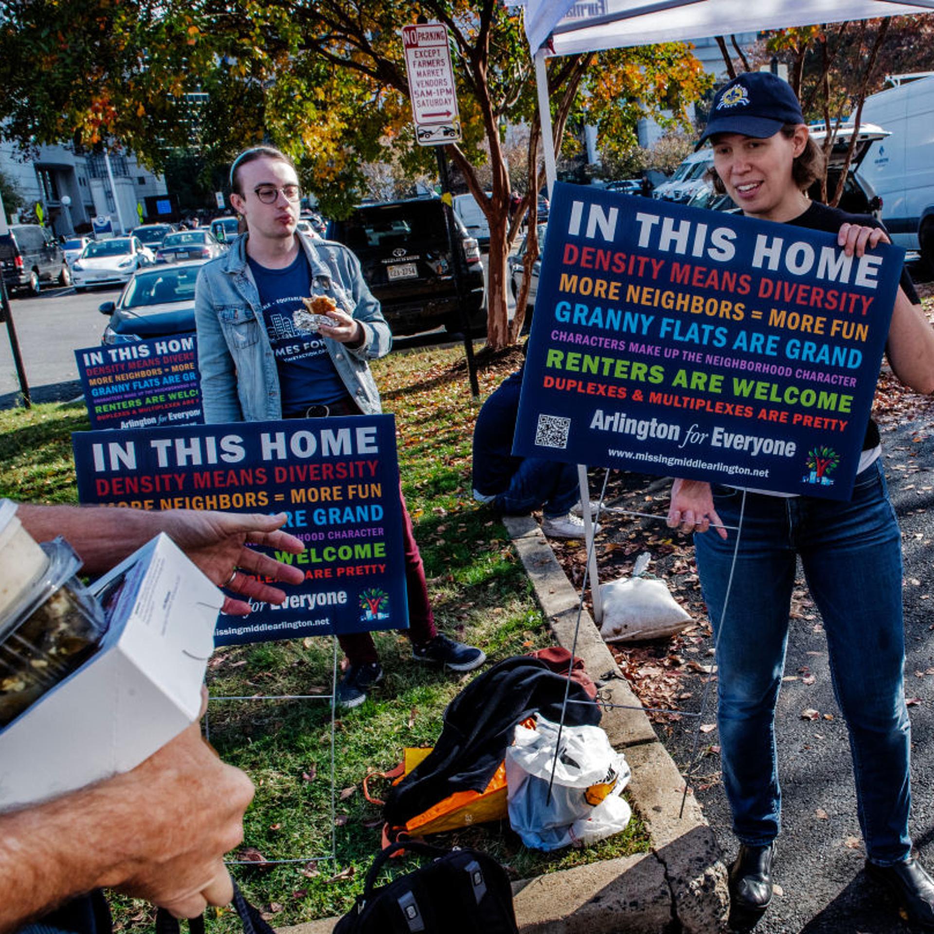 Arlington citizens at a county board meeting with their signs demanding more affordable houseing, on November 12 in Arlington, VA.