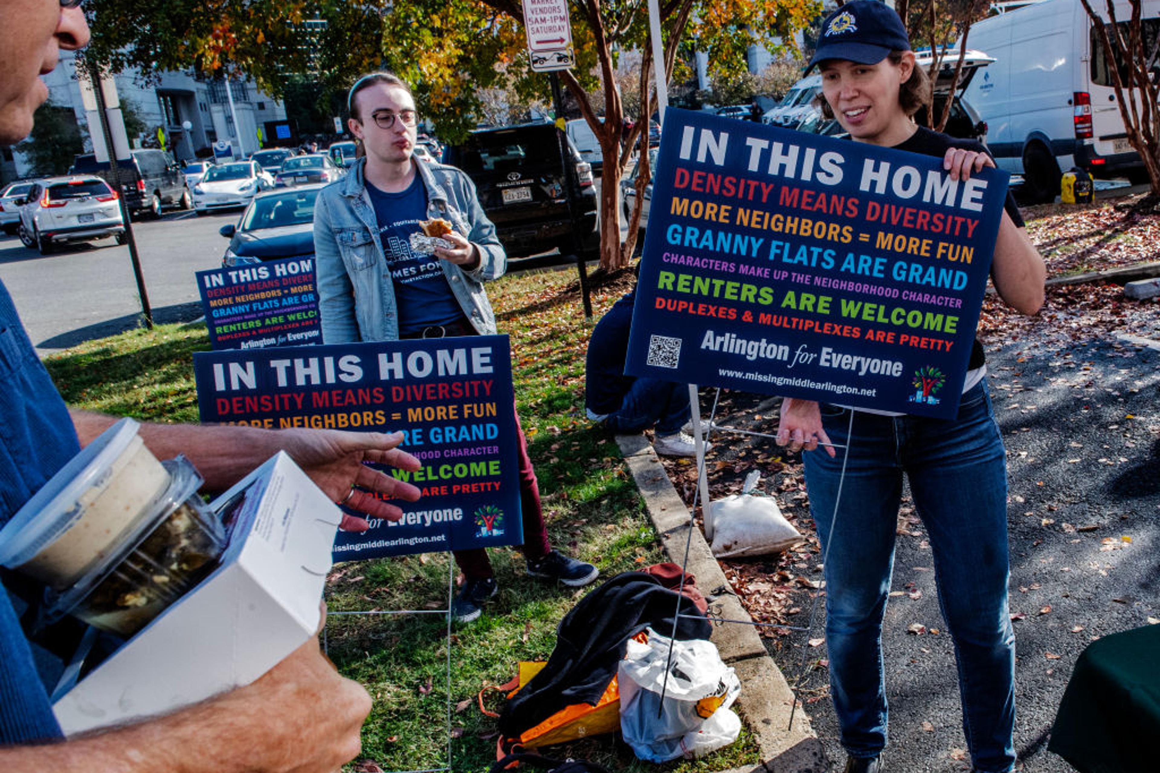 Arlington citizens at a county board meeting with their signs demanding more affordable houseing, on November 12 in Arlington, VA.