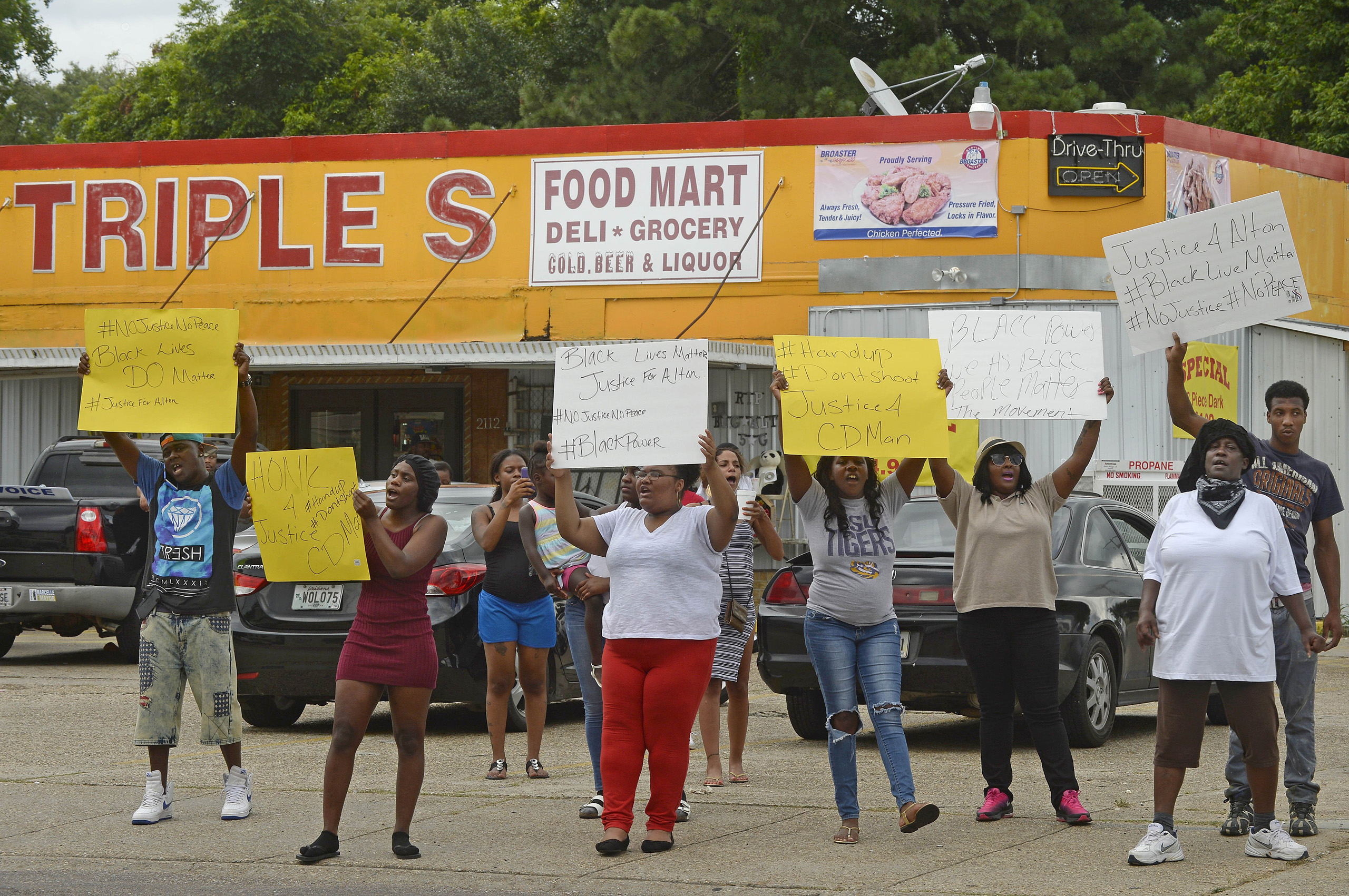Family and friends of Alton Sterling protest on the corner of Fairfields Ave. and North Foster Drive Tuesday afternoon, July 5, 2016, after was fatally shot in an altercation with Baton Rouge Police just after midnight, in the parking lot of the Triple S