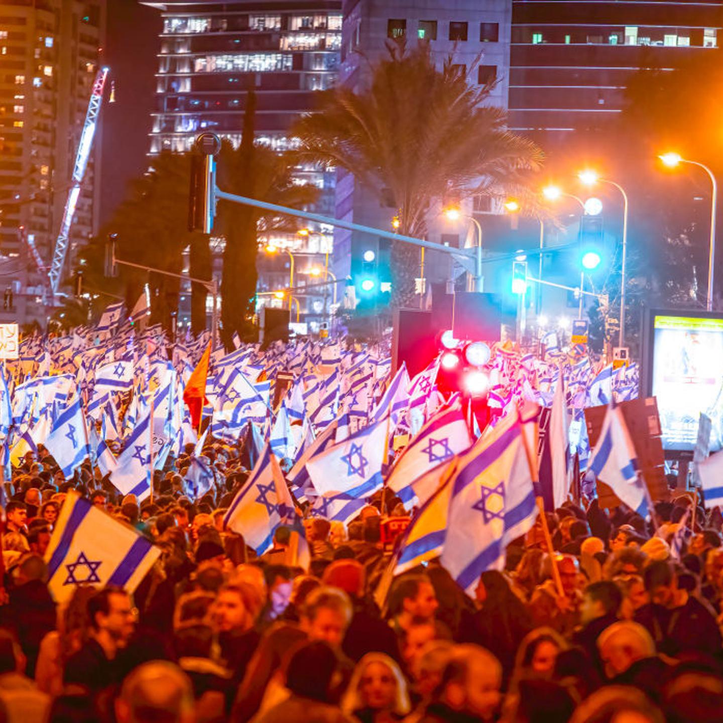 Crowd of protesters wave flags and placards during the