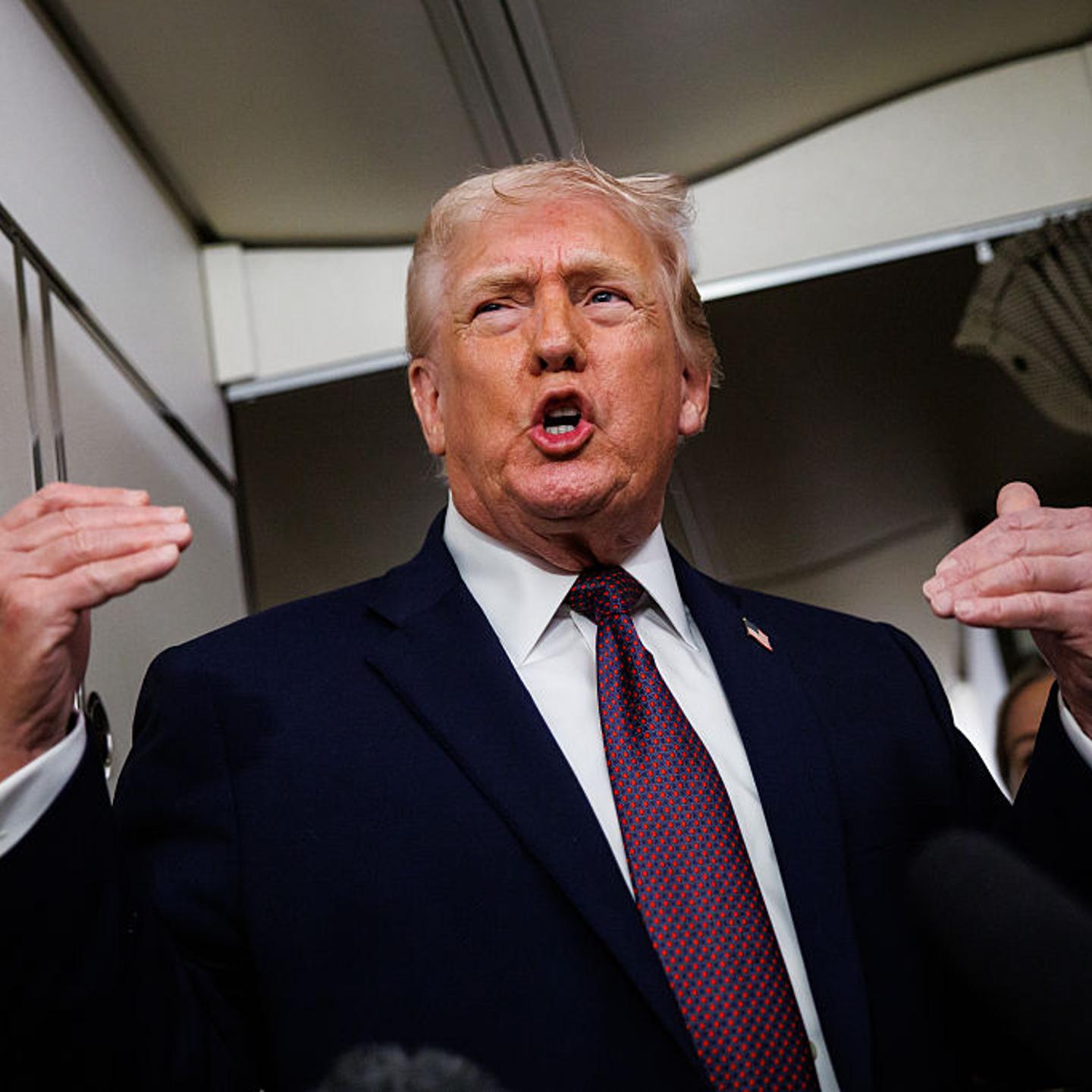 U.S. President Donald Trump takes questions from the members of the press aboard Air Force One on Jan. 11, 2026.