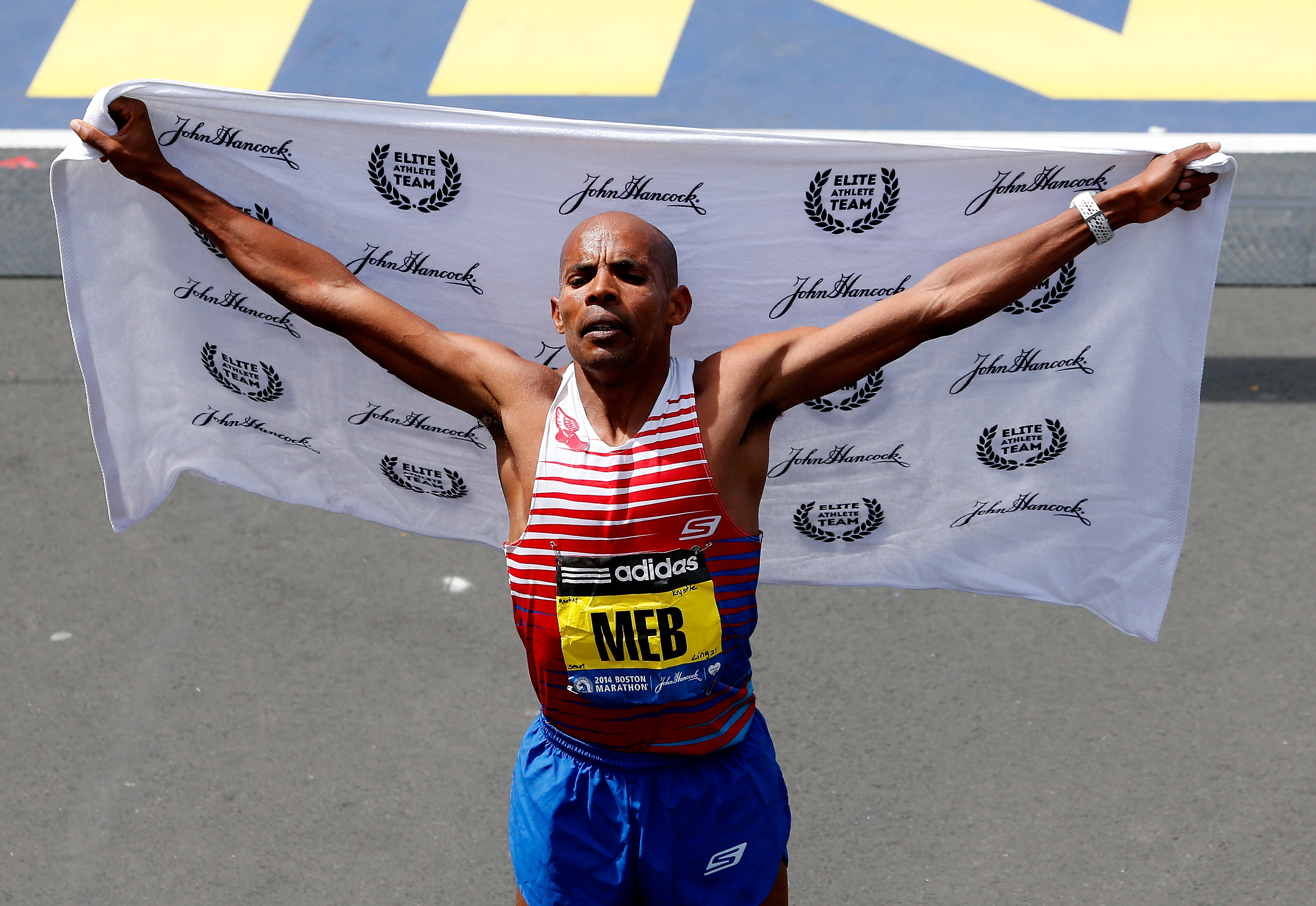 Meb Keflezighi crosses the finish line of the 118th Boston Marathon on April 21, 2014 in Boston, Massachusetts.