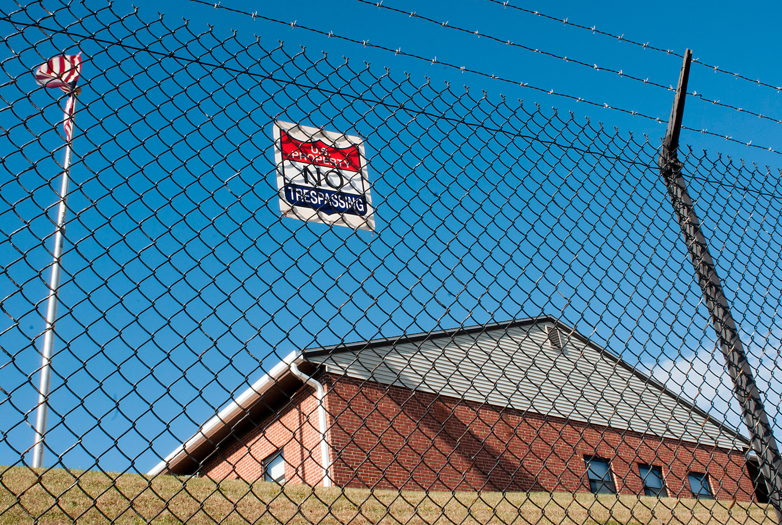 A barbed wire fence protects a U.S. Army Reserve building on North Lake Ave. in Worcester, Mass. Monday, Nov. 16, 2015. A man broke into the central Massachusetts Army Reserve center and made off with 16 weapons, and officials said Monday they were still