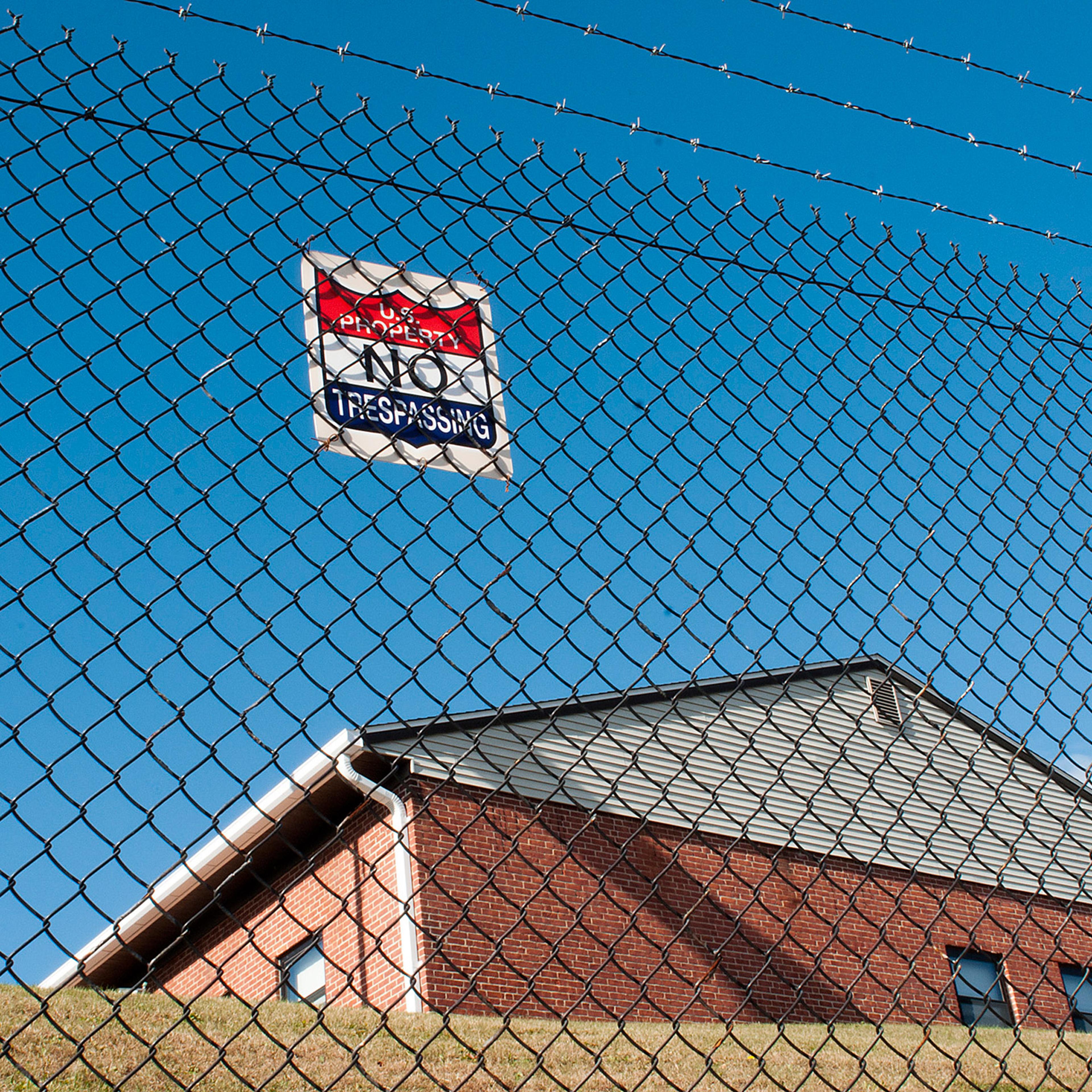 A barbed wire fence protects a U.S. Army Reserve building on North Lake Ave. in Worcester, Mass. Monday, Nov. 16, 2015. A man broke into the central Massachusetts Army Reserve center and made off with 16 weapons, and officials said Monday they were still