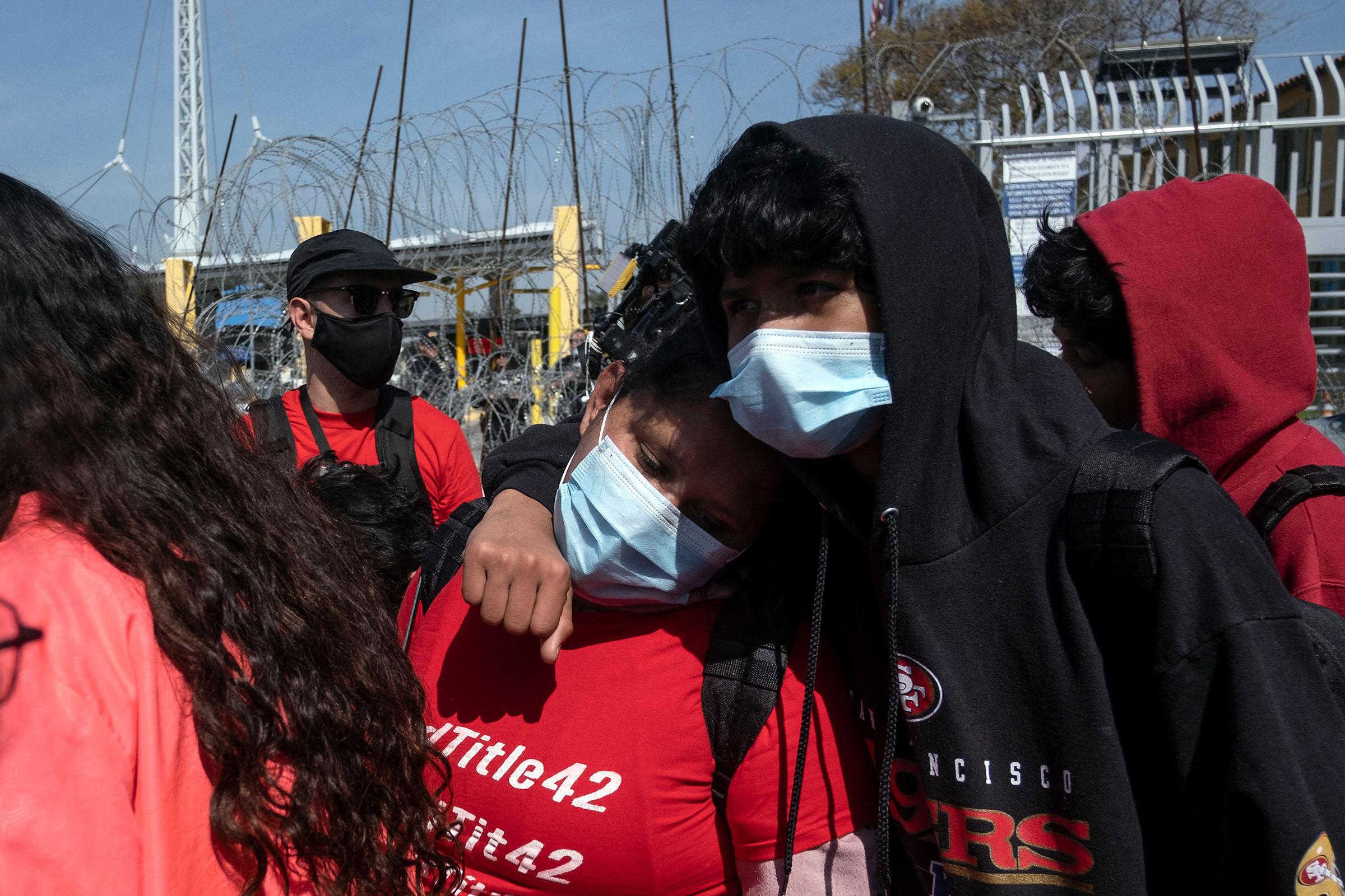 Asylum seekers react after been rejected at the border during a protest against Title 42 policy on the Mexican side of the San Ysidro Crossing port in Tijuana, Baja California state, Mexico, on March 21, 2022.