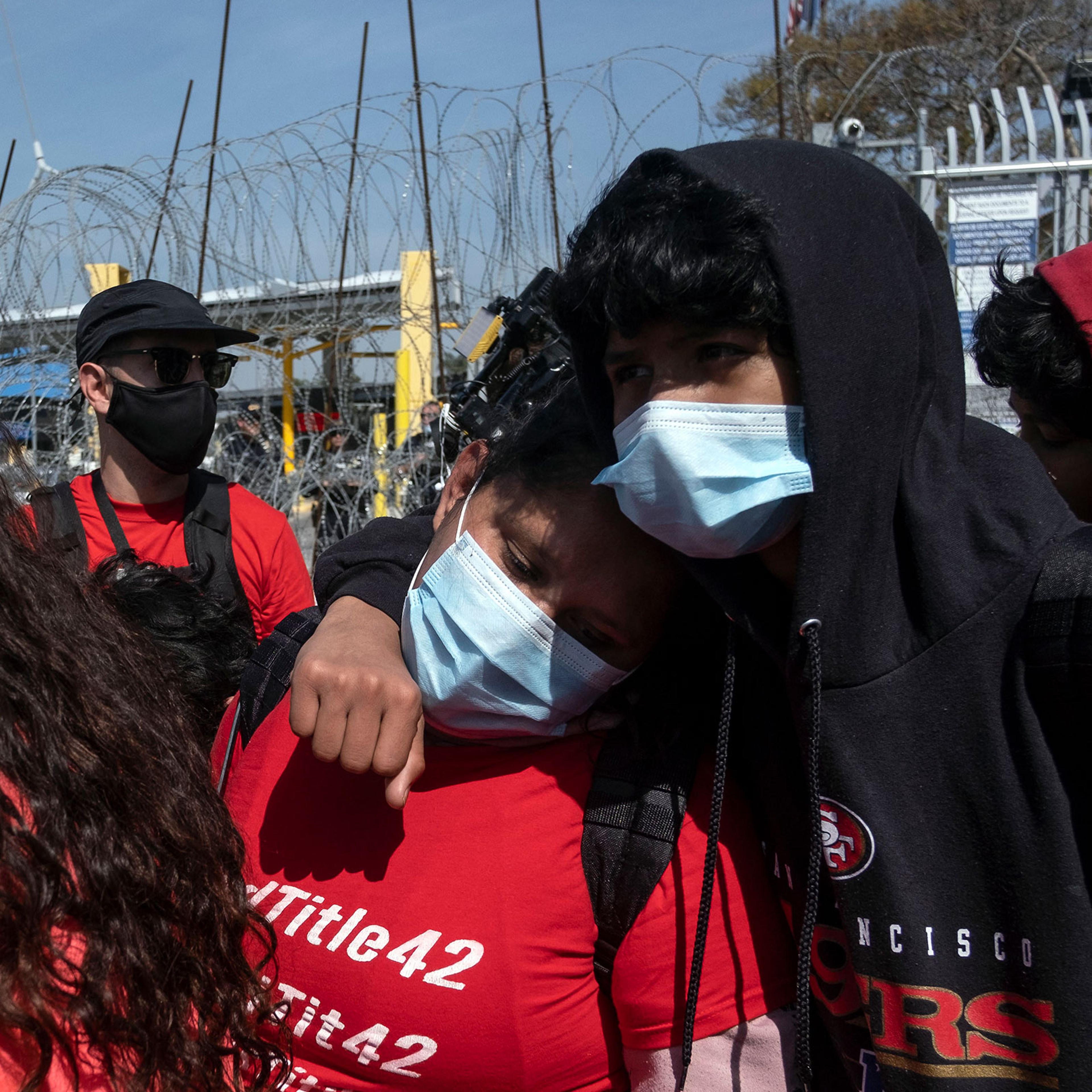 Asylum seekers react after been rejected at the border during a protest against Title 42 policy on the Mexican side of the San Ysidro Crossing port in Tijuana, Baja California state, Mexico, on March 21, 2022.