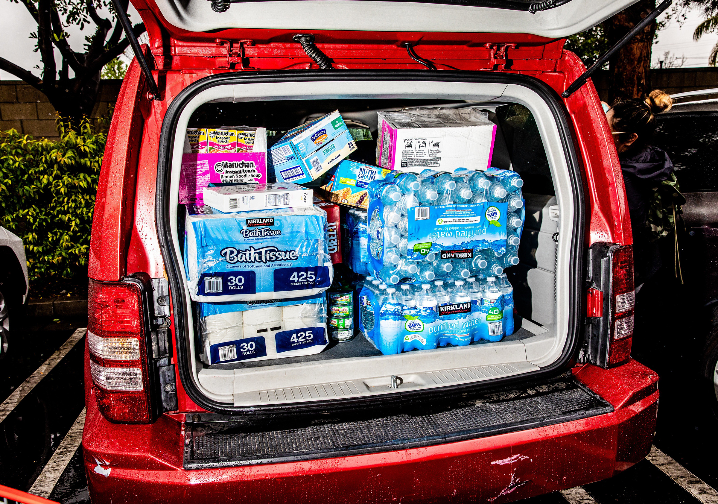 Umberto Sanchez and Maria Hernandez from El Salvador, who live in Burbank, Calif., stock up at a Costco Wholesale in response to the coronavirus pandemic on March 13, 2020.