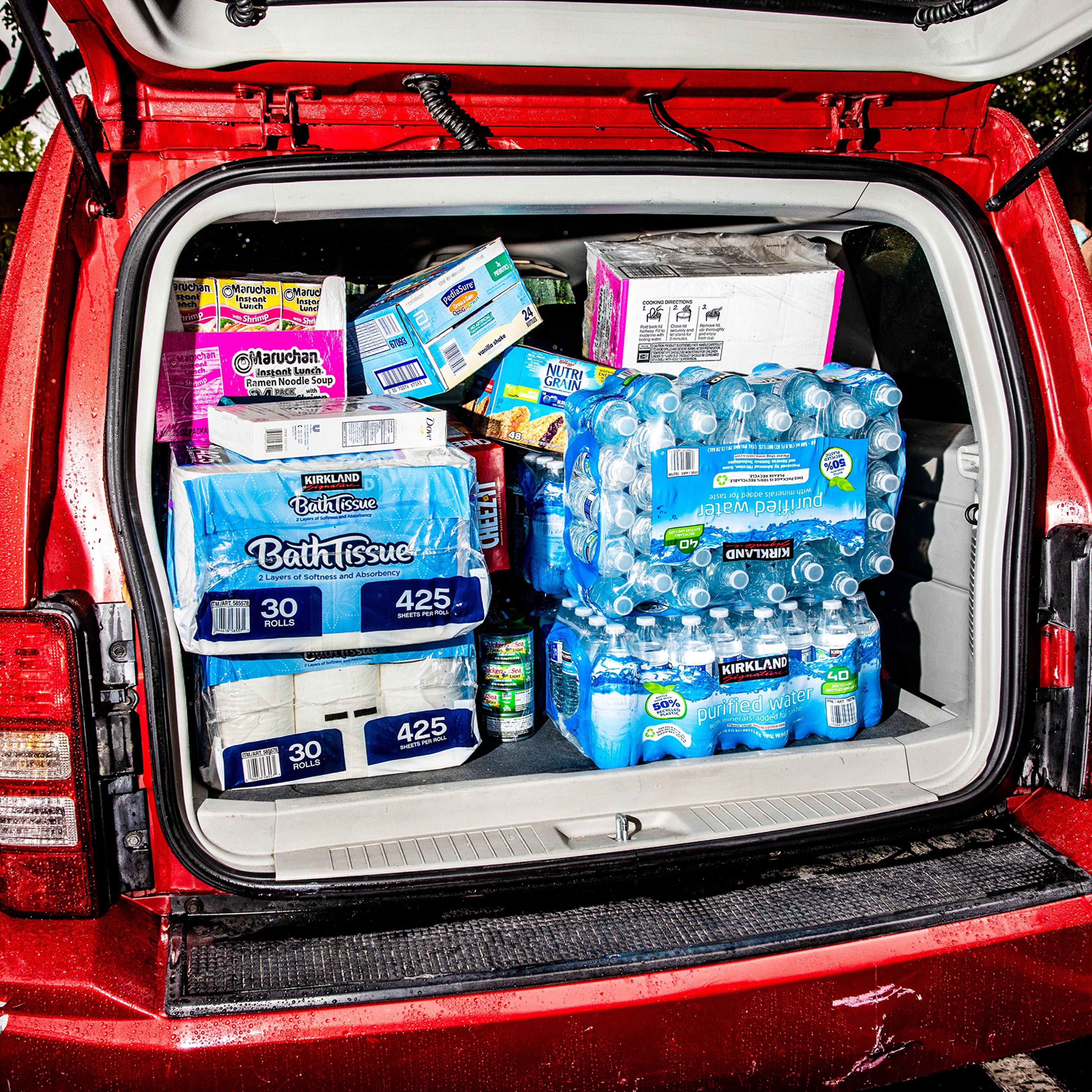 Umberto Sanchez and Maria Hernandez from El Salvador, who live in Burbank, Calif., stock up at a Costco Wholesale in response to the coronavirus pandemic on March 13, 2020.