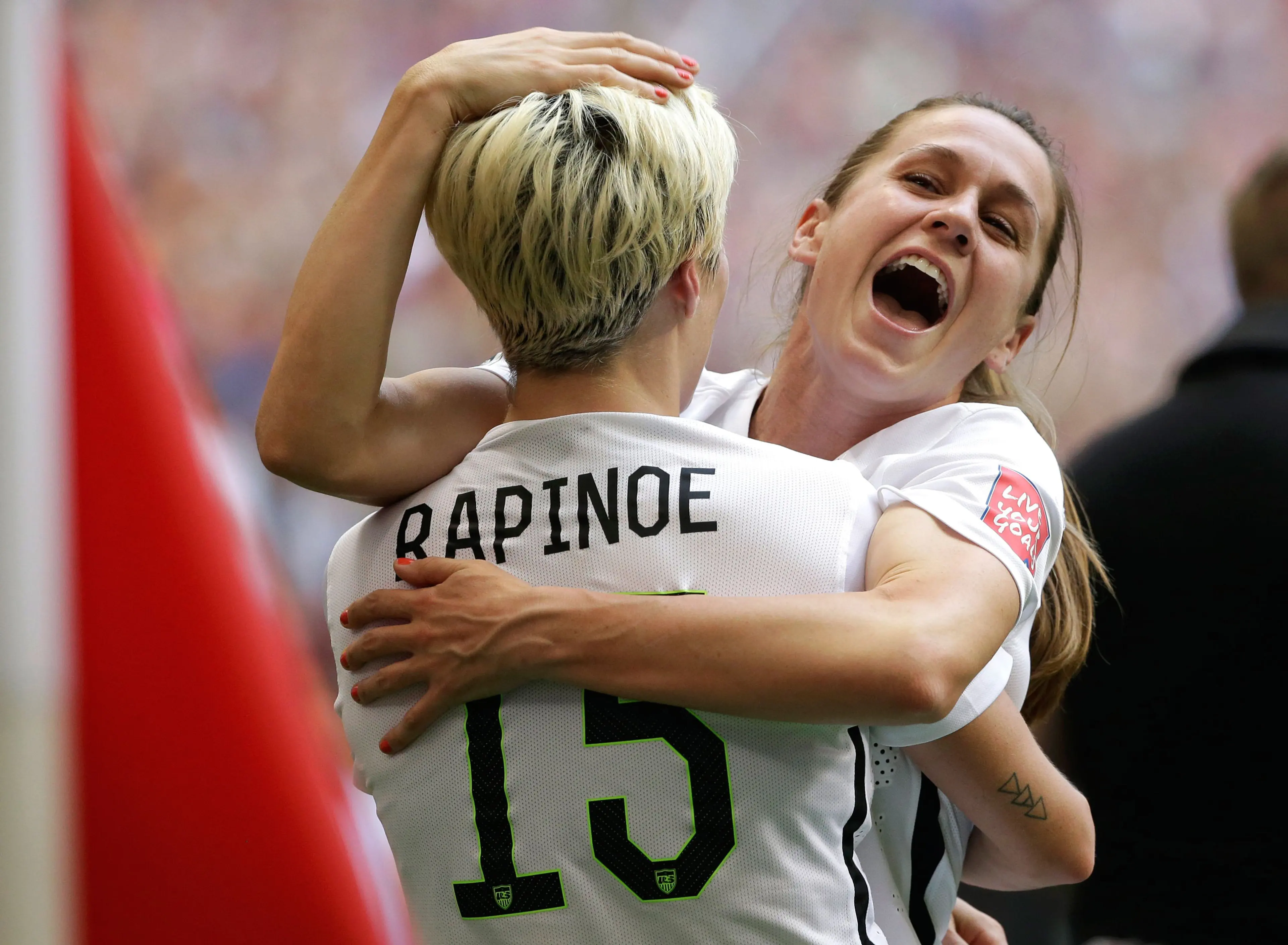 United States' Heather O'Reilly, right, hugs Megan Rapinoe (15) after the U.S. beat Japan 5-2 in the FIFA Women's World Cup soccer championship in Vancouver, British Columbia, Canada, Sunday, July 5, 2015. (AP Photo/Elaine Thompson)