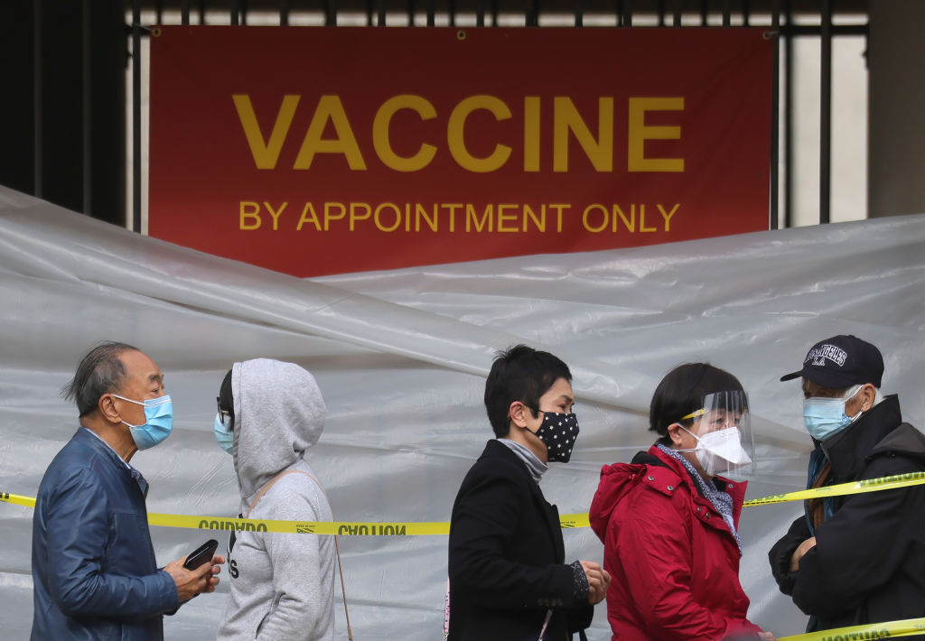 People with appointments stand in line to receive the COVID-19 vaccine at a vaccination site at Lincoln Park in East Los Angele