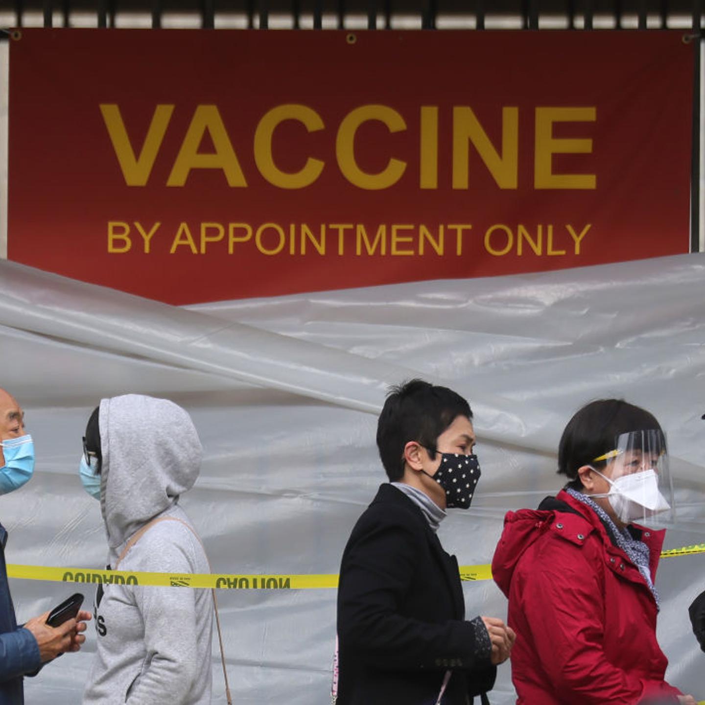 People with appointments stand in line to receive the COVID-19 vaccine at a vaccination site at Lincoln Park in East Los Angele