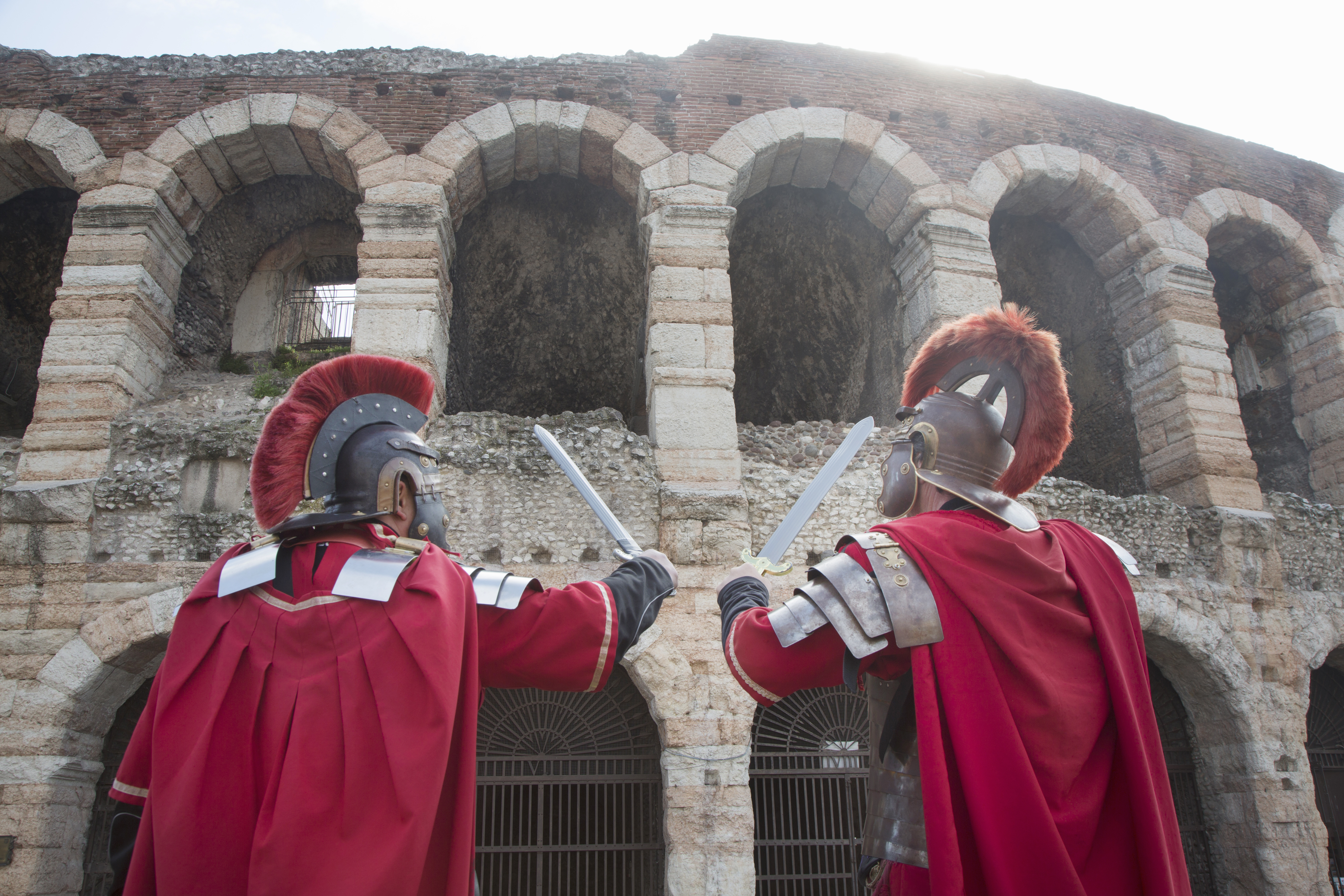 Two men dressed as Romans standing in front of the Coliseum