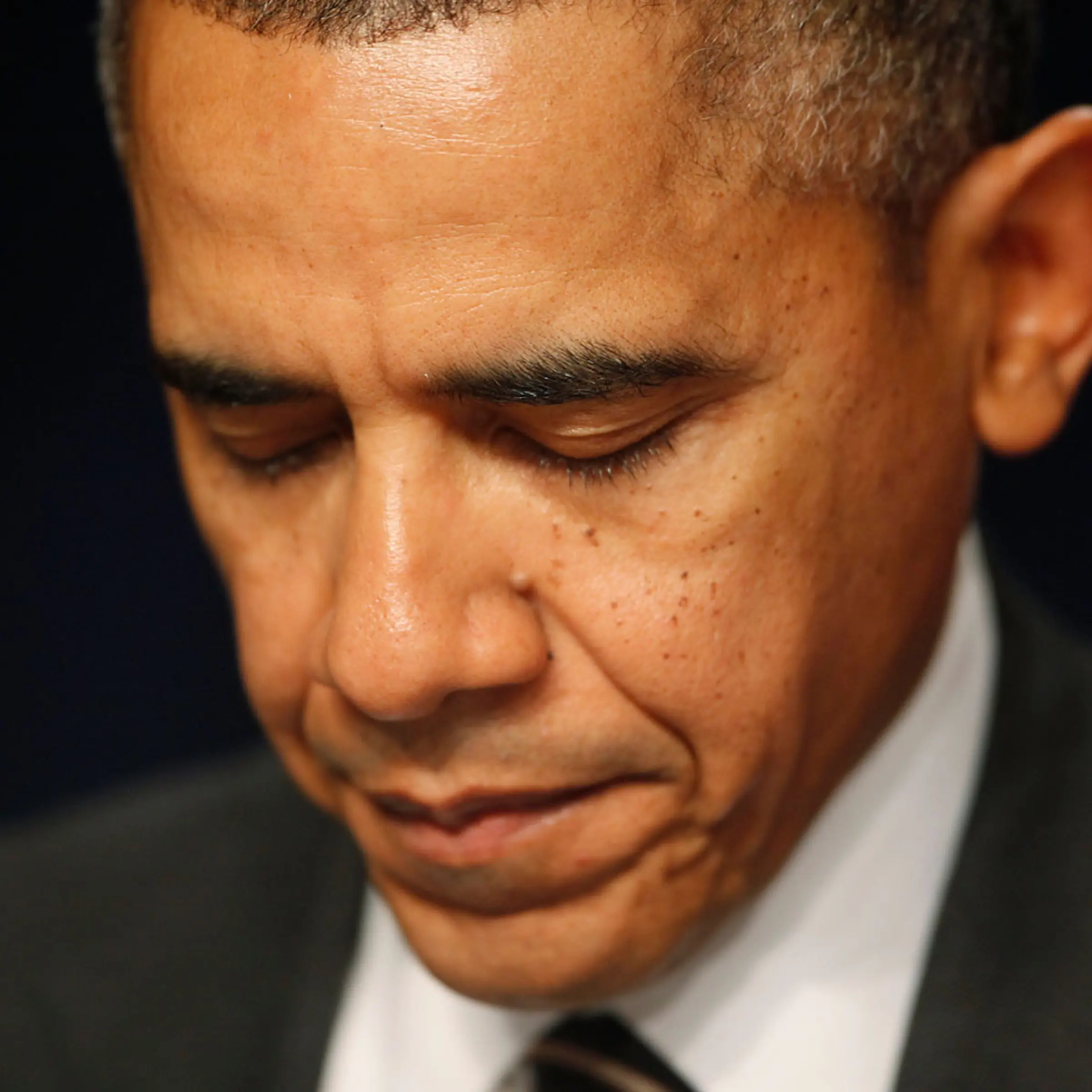 President Barack Obama closes his eyes as a prayer is offered at the National Prayer Breakfast in Washington, Feb. 6, 2014.