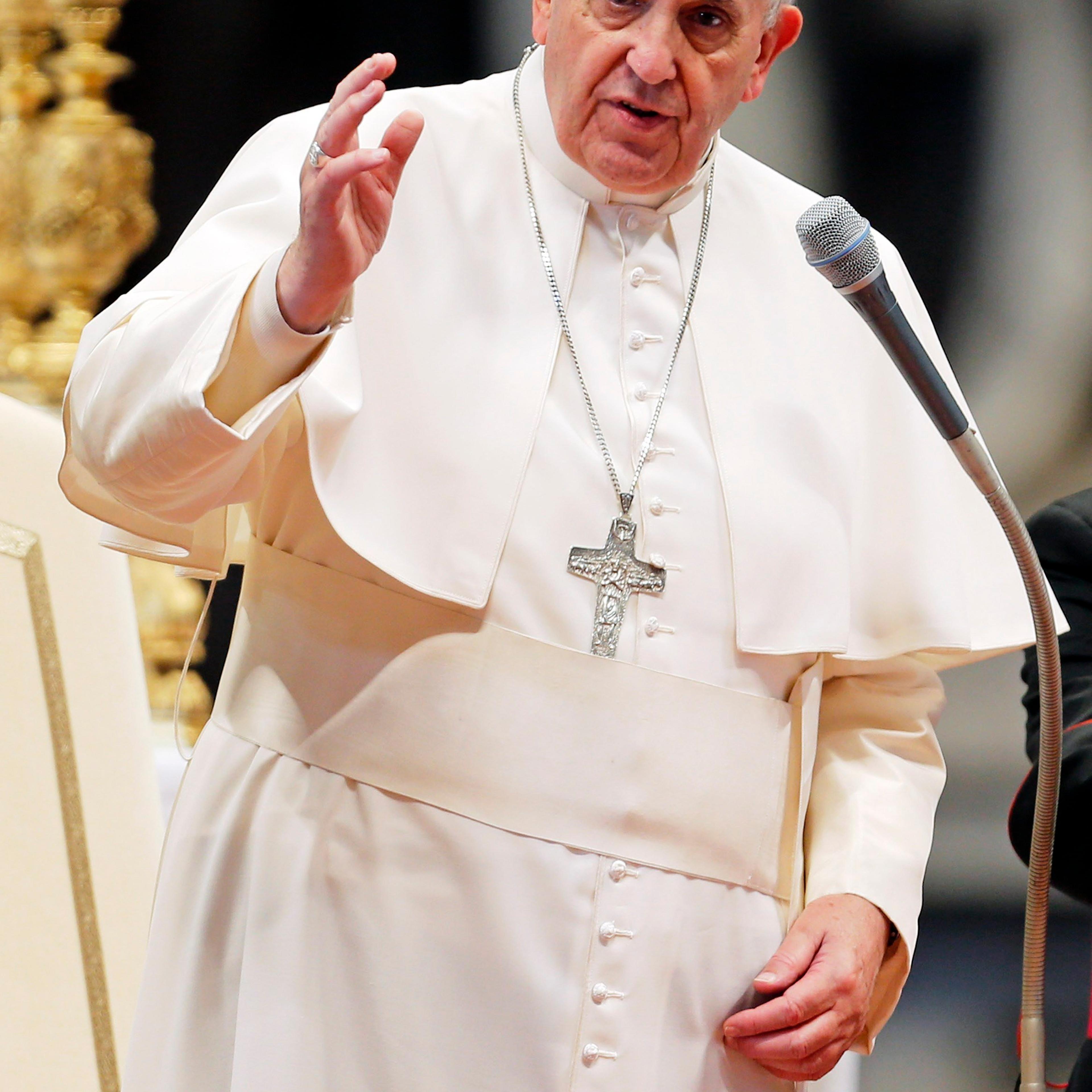 Pope Francis delivers his blessing at the end of an audience with Italian athletes in St. Peter's Basilica at the Vatican