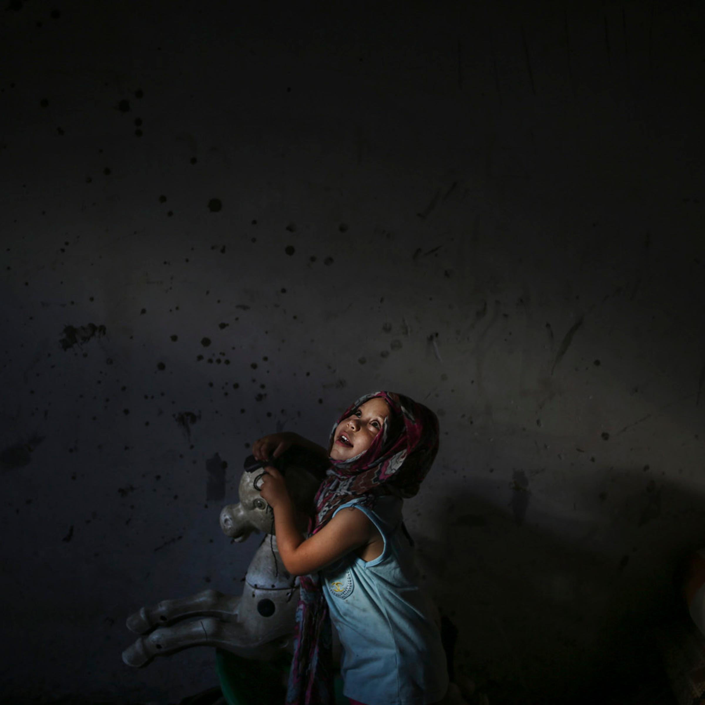 A Palestinian refugee girl Nour Soboh 4 years , palys beside her horse in her family house in Bait Lahiya town, North Gaza StripHOLD TO MARIA MANN