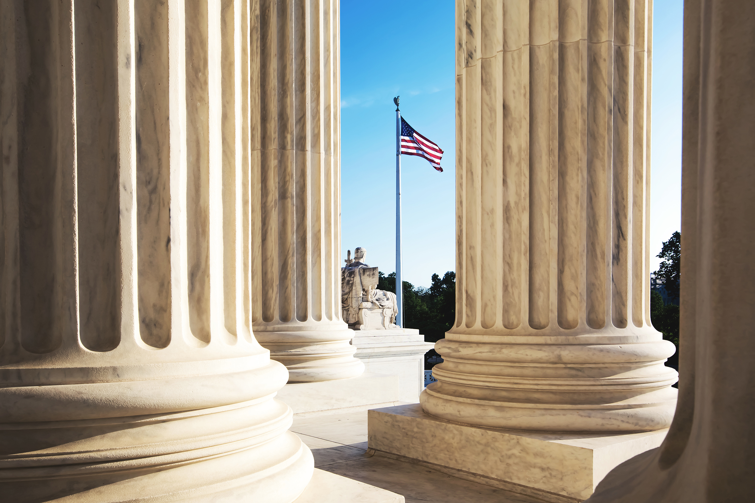 American Flag Seen Through Columns