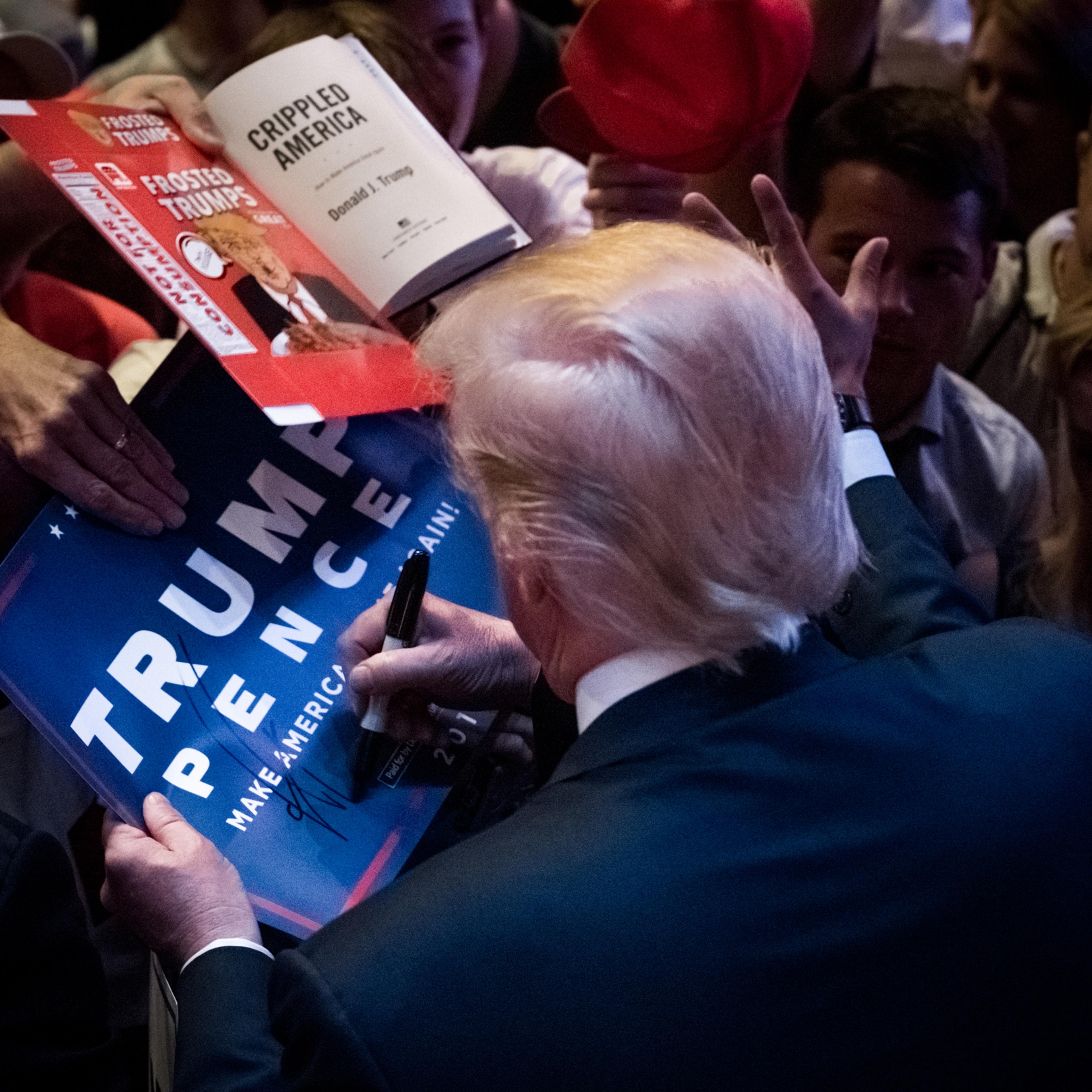 GOP Presidential nominee, Donald J. Trump, signs memorabilia while campaigning in Portland, Maine, on Thursday August 4, 2016. The candidate has faced a controversial week in the media but saw a positive response during the rally at City Hall. (Photo by