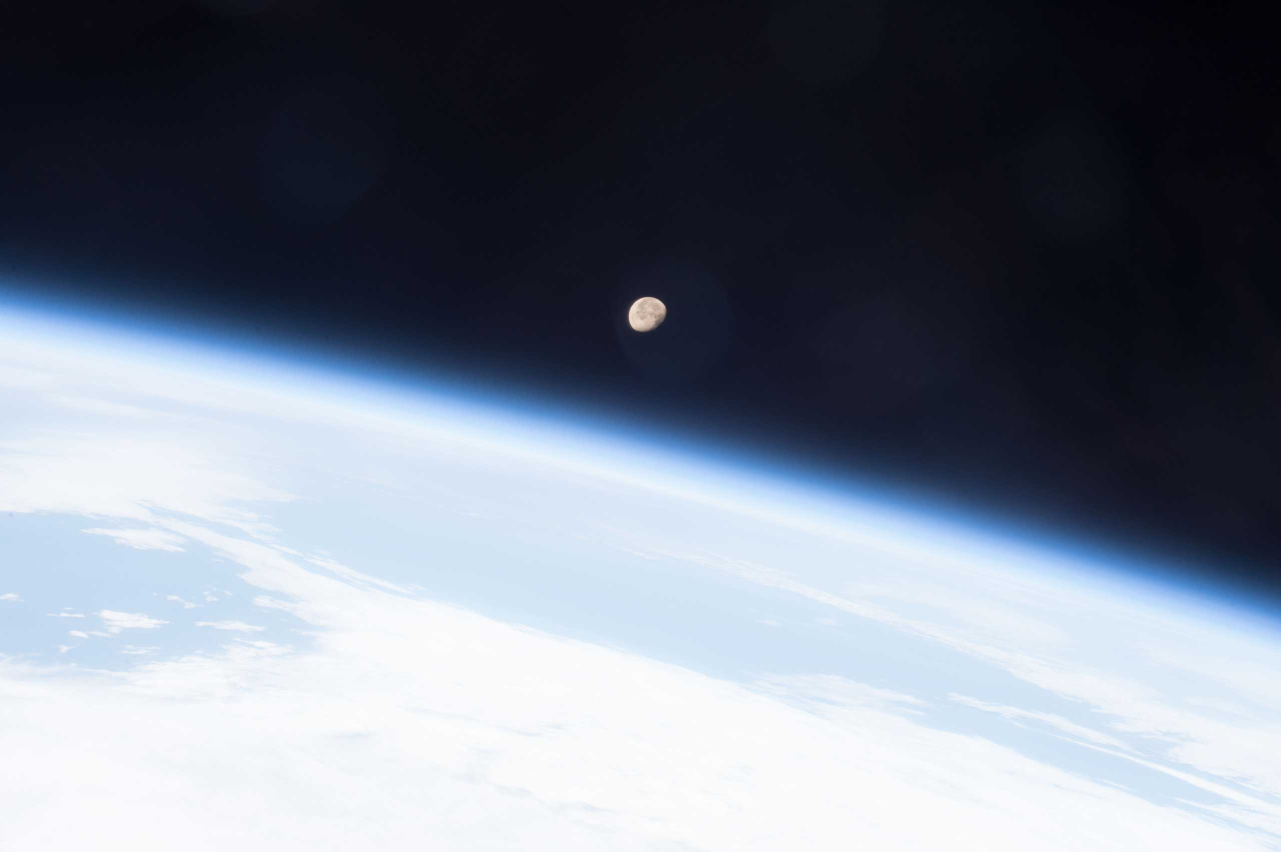 The Moon shines brightly on planet Earth's horizon in this image snapped from the International Space Station May 7, 2015 by the crew of Expedition 43 led by Commander Terry Virts, NASA astronaut.