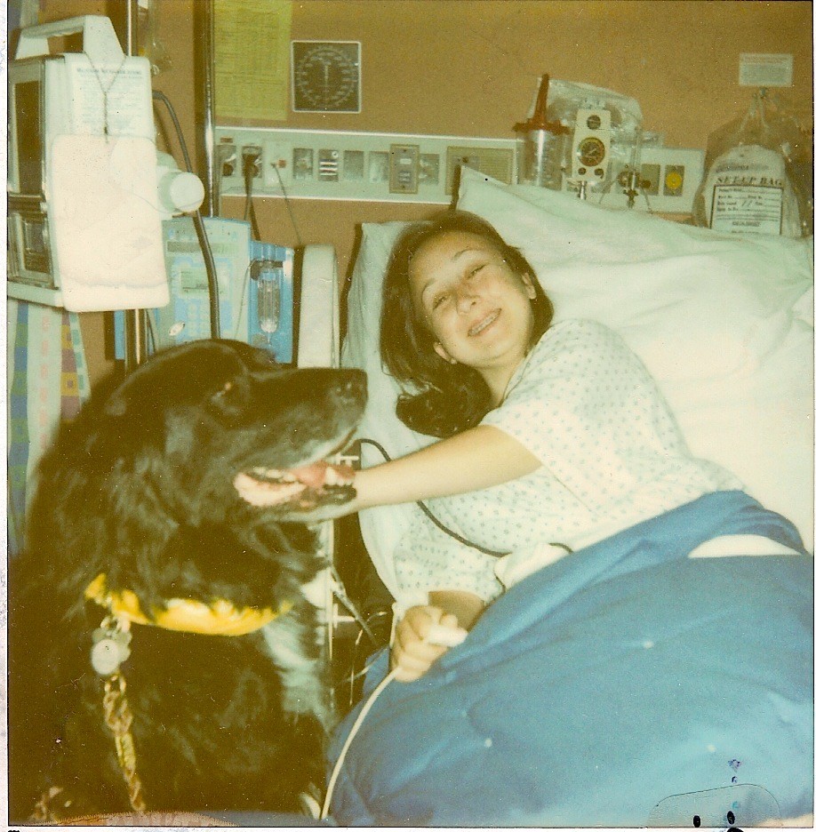 The author, at 14 years old, visited in the hospital by a therapy dog.