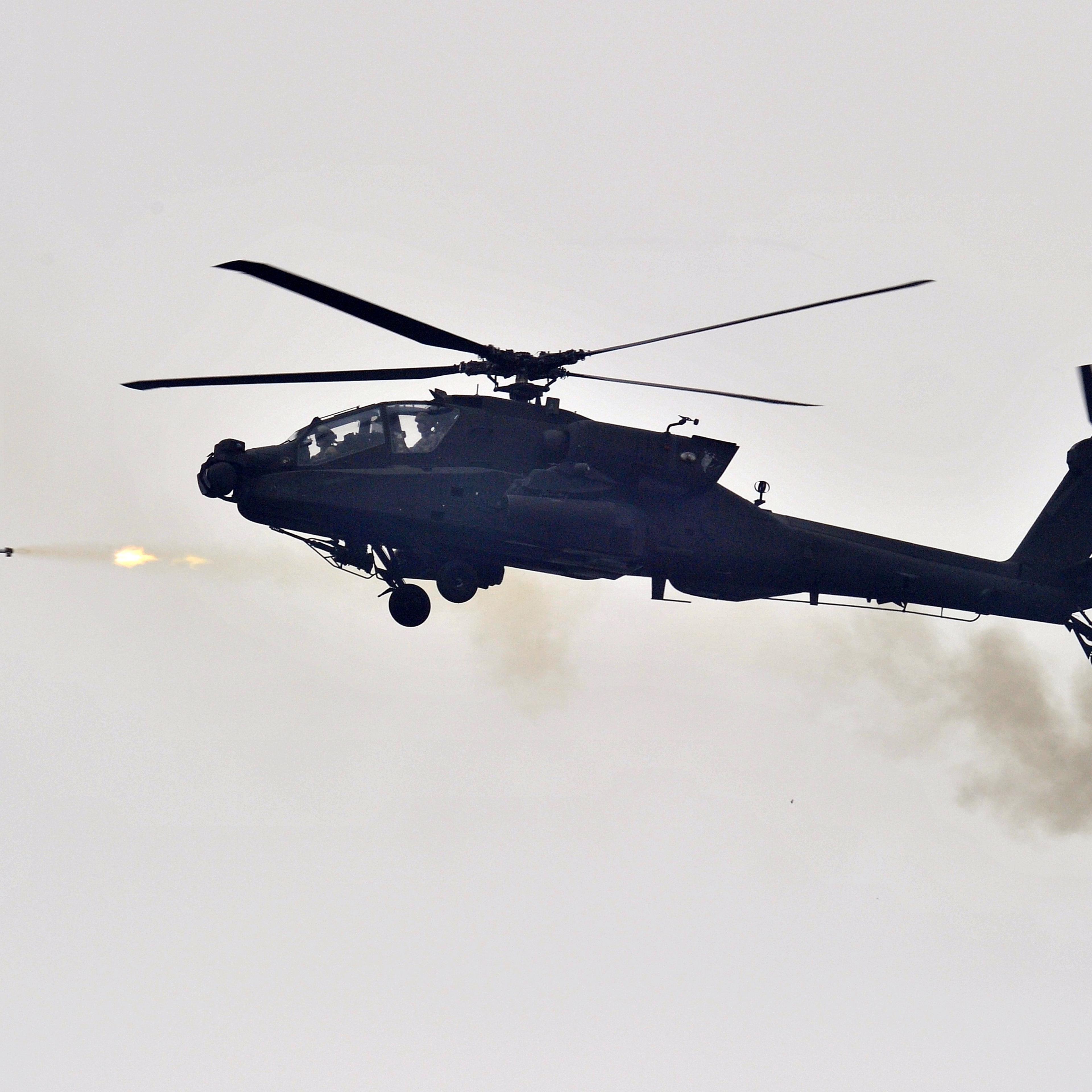 A US AH-64 Apache helicopter fires rocke