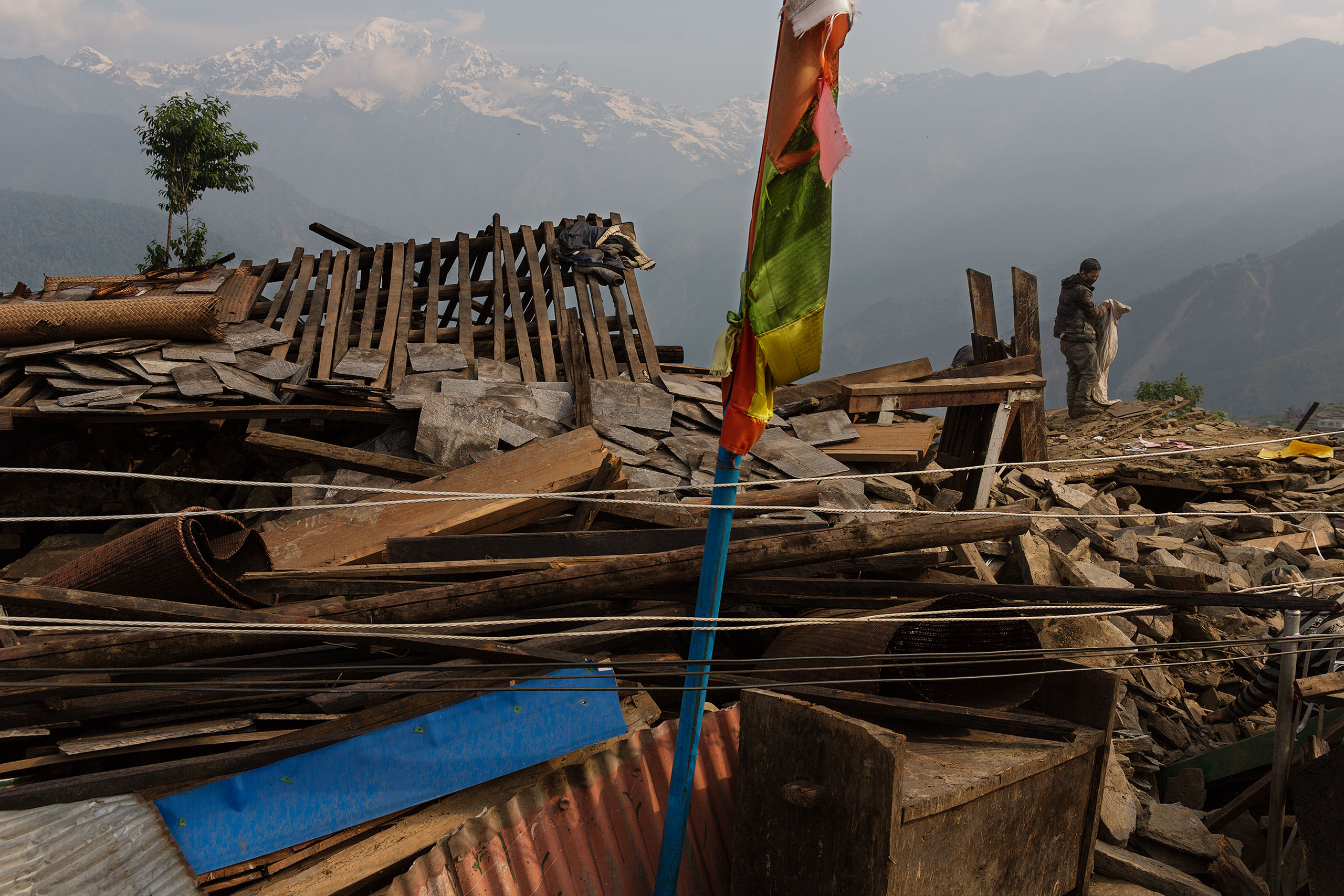 Nepal earthquake. Barpak, the epicenter of the earthquake. Inhabitants salvaging building materials and possessions from their destroyed houses. by James Nachtwey