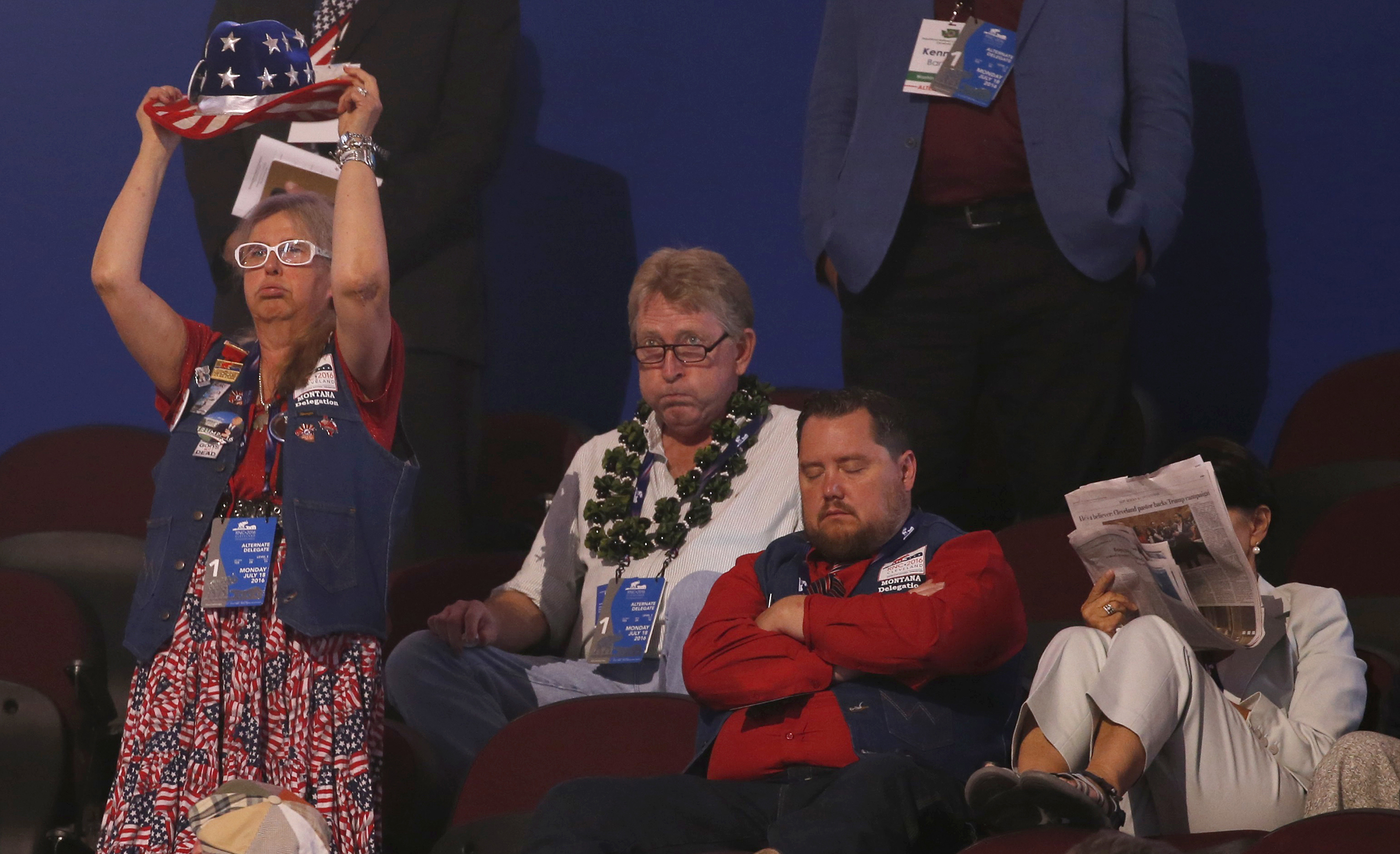 Alternate delegates and visitors watch with a variety of expression at the Republican National Convention in Cleveland, Ohio, on July 18, 2016.