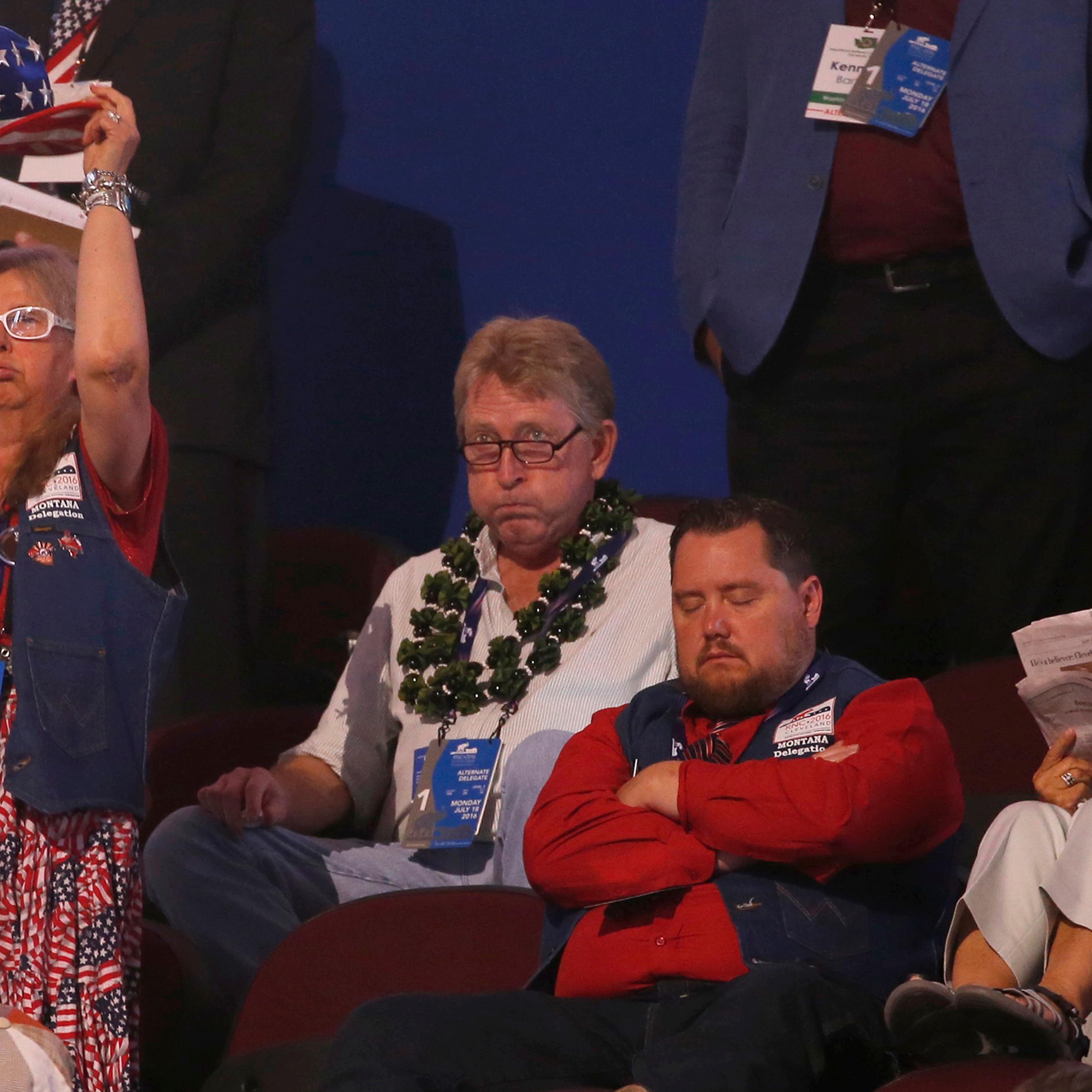 Alternate delegates and visitors watch with a variety of expression at the Republican National Convention in Cleveland, Ohio, on July 18, 2016.