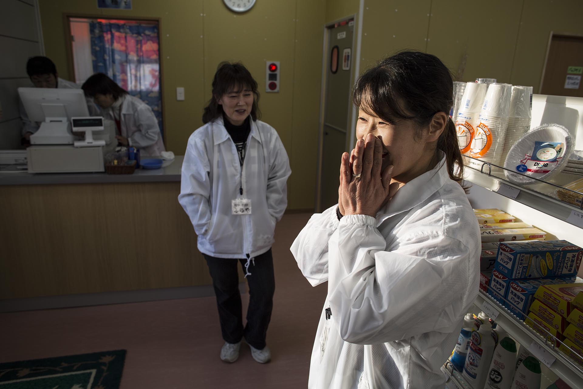 Miho Watanabe rejoices with fellow manager Junko Kotani at the opening of their grocery store in Tamura, Fukushima prefecture, the first shop to open since the nuclear disaster in 2011 forced the village to evacuate