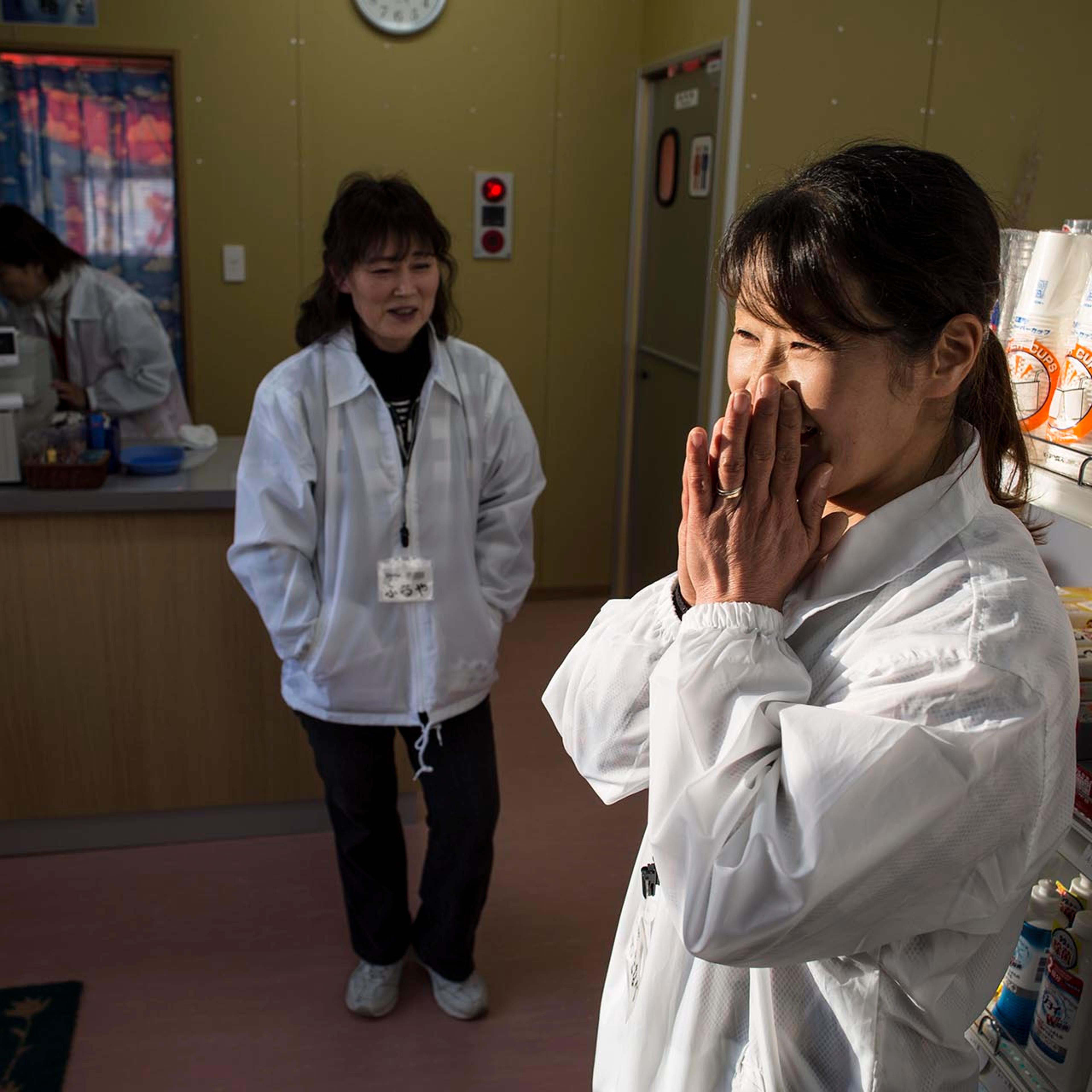 Miho Watanabe rejoices with fellow manager Junko Kotani at the opening of their grocery store in Tamura, Fukushima prefecture, the first shop to open since the nuclear disaster in 2011 forced the village to evacuate