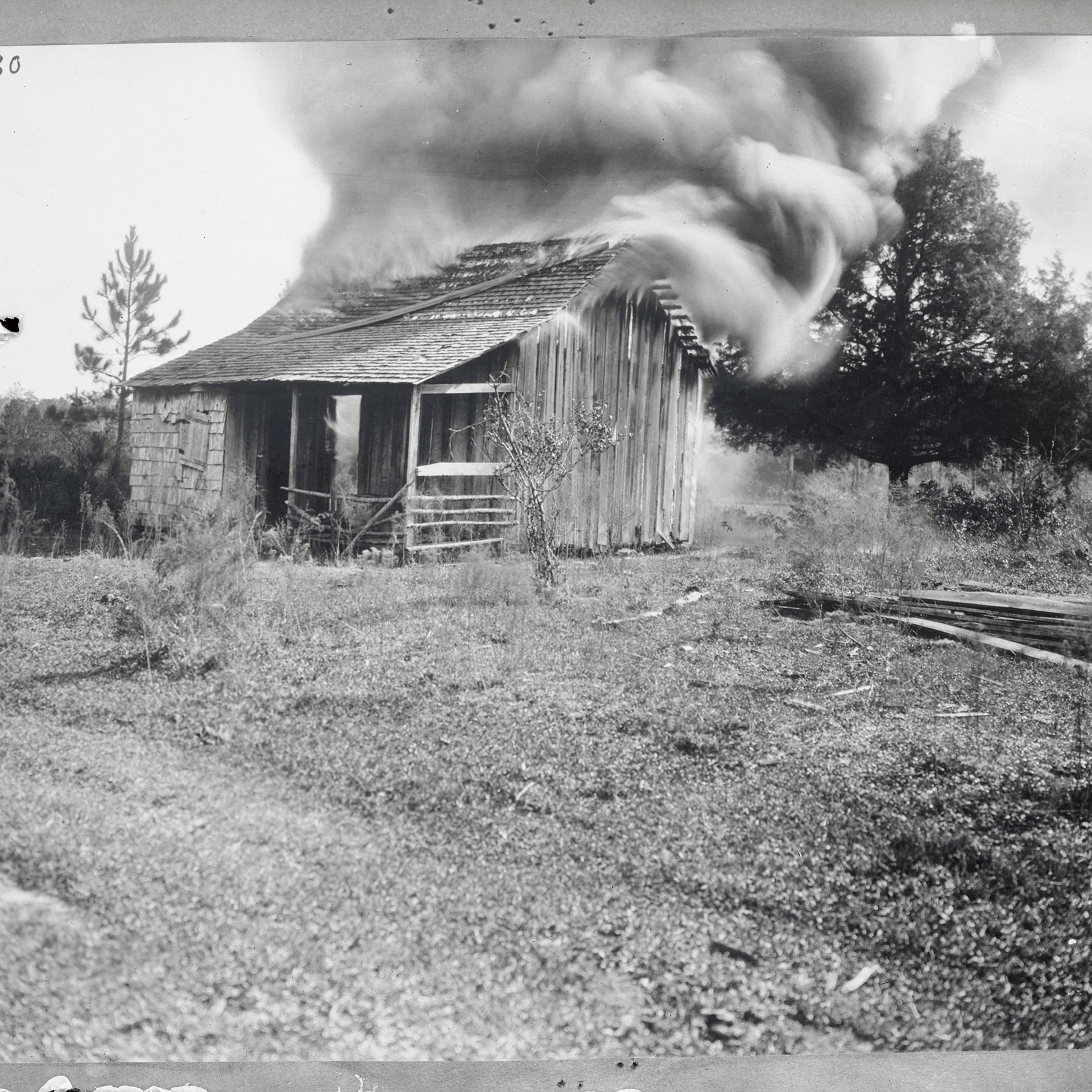 A home burns on Jan. 9, 1923, during a white mob’s attacks on the Black community of Rosewood, Fla.