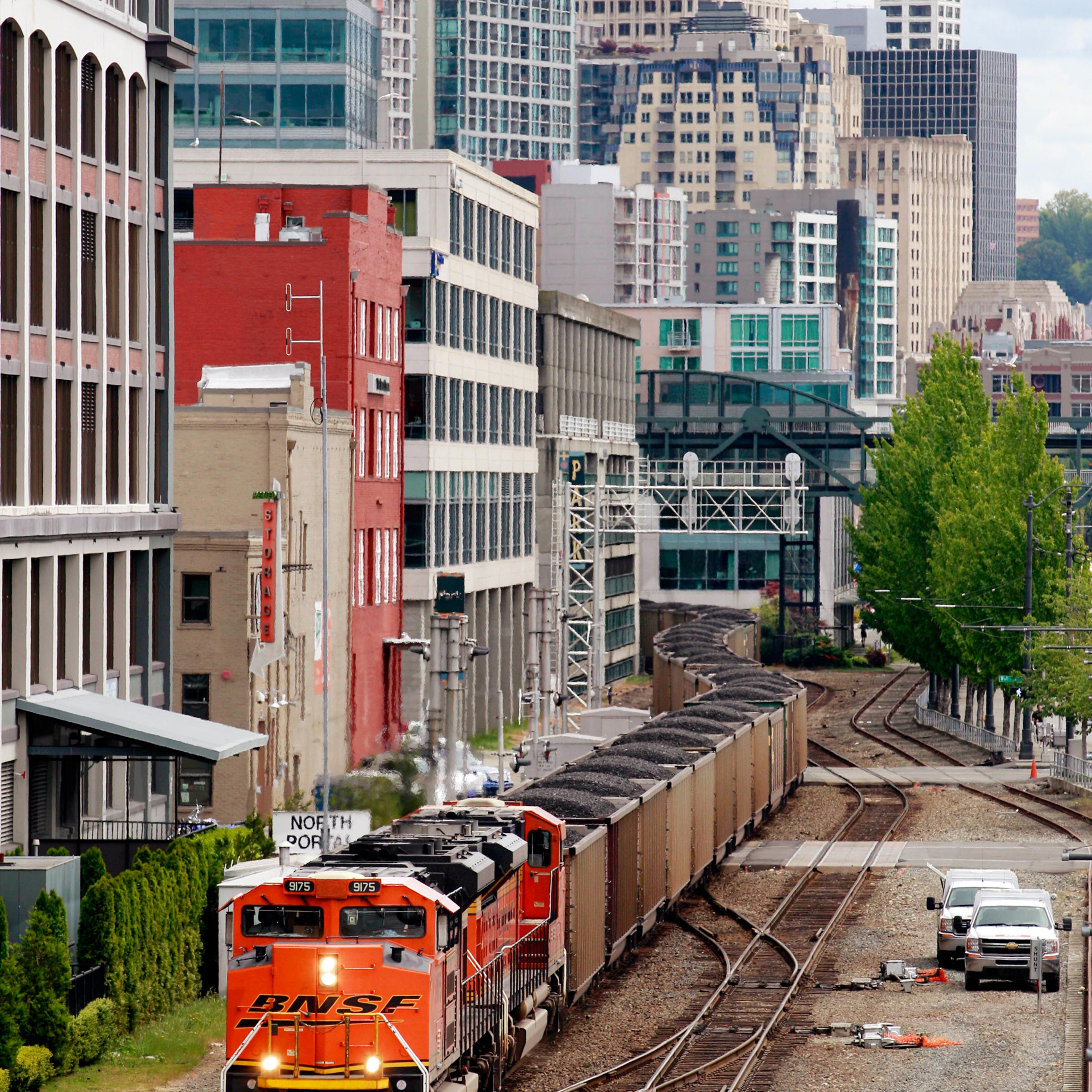 A train hauls coal bound for Canada through downtown Seattle