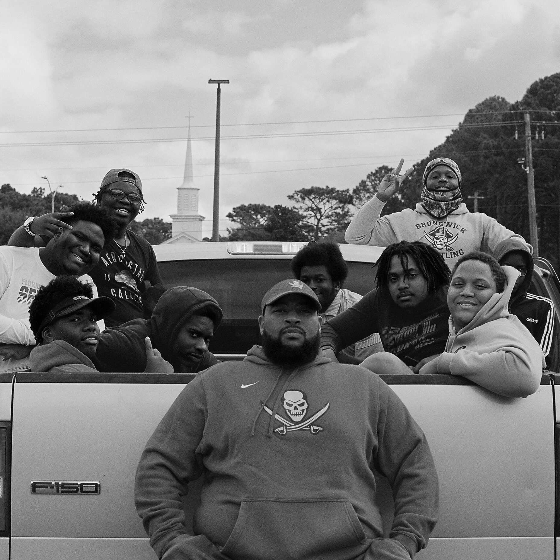 Jason Vaughn, coach of the Brunswick High School football team with his players who volunteered to canvas neighborhoods for early voting.
