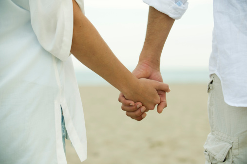 couple-holding-hands-rear-view