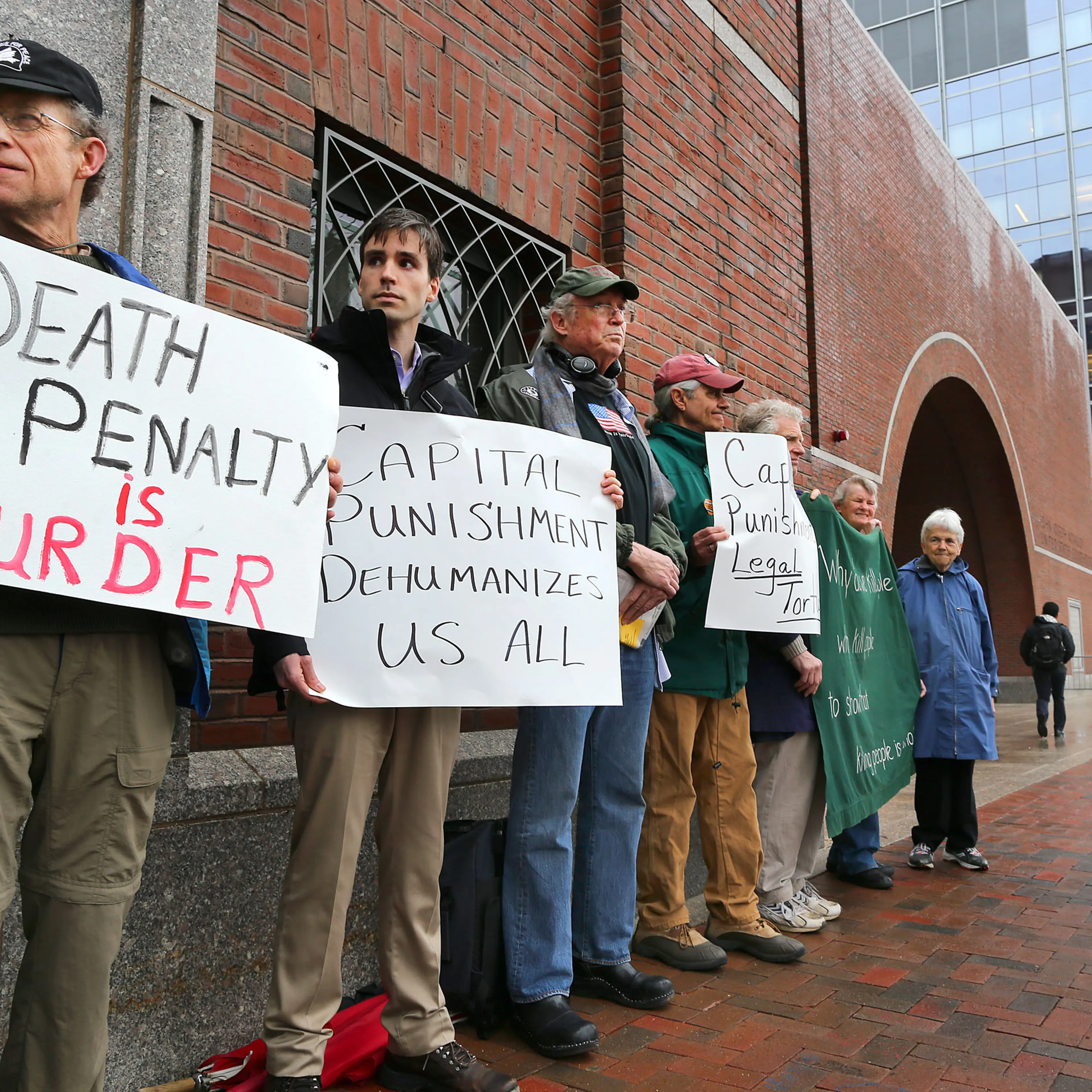 Demonstrators against the death penalty stand outside the Moakley Federal Court during first day of the penalty phase for Boston Marathon bomber Dzhokhar Tsarnaev on April 21, 2015 in Boston.