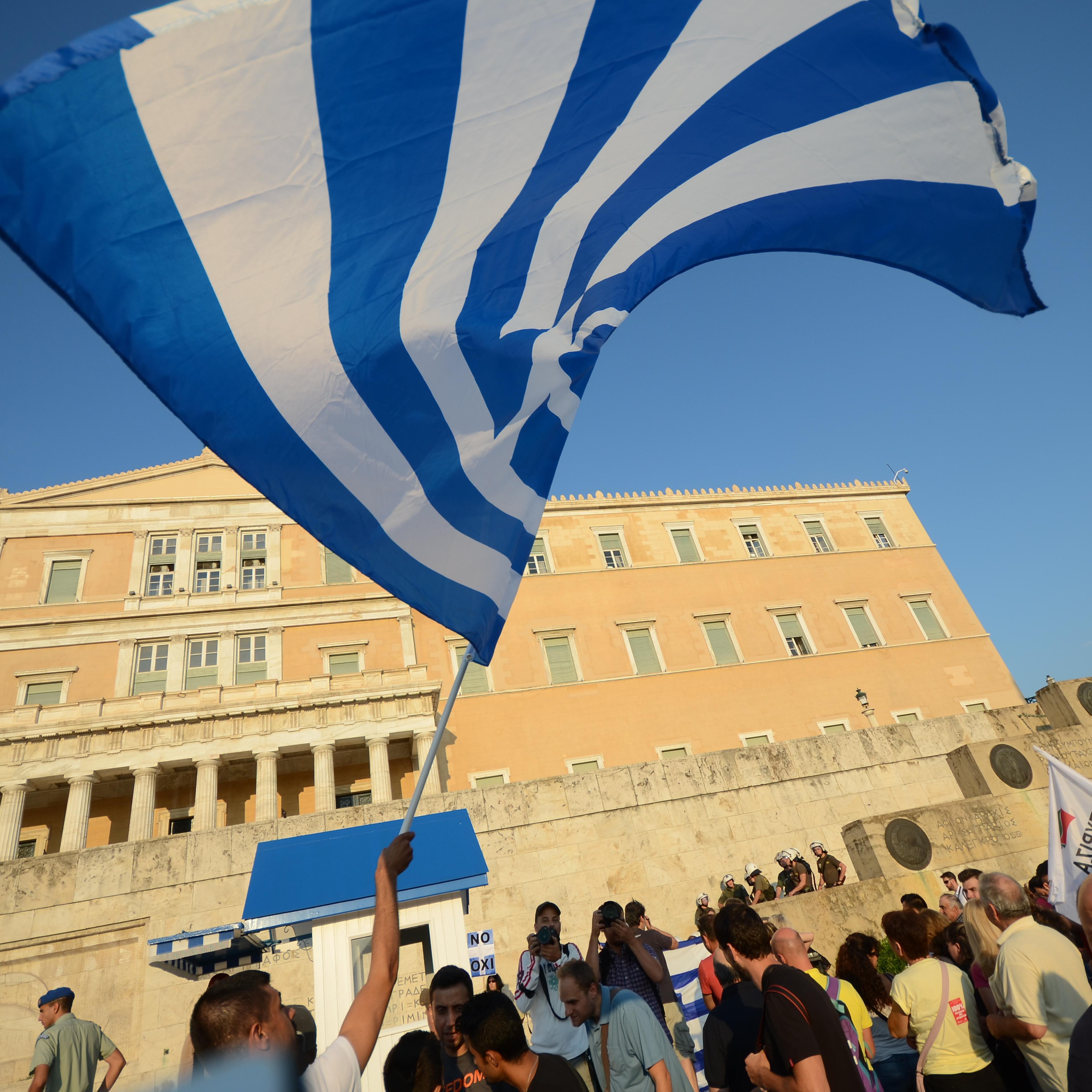 People waving flags at Syntagma square. Greeks demonstrate