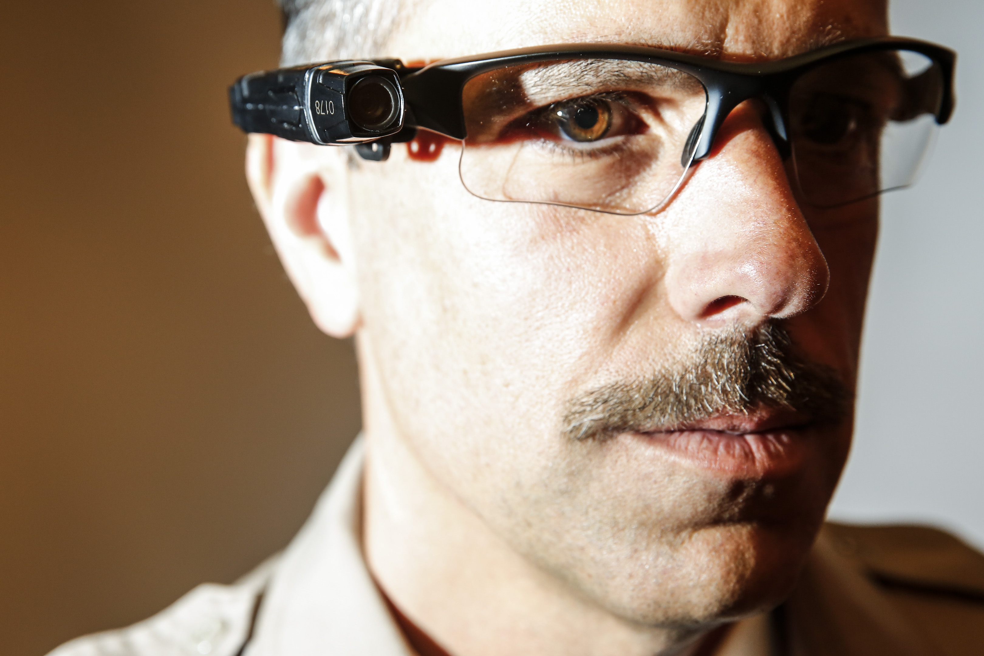 County of Los Angeles Sheriff's Lt. Chris Marks poses wearing the Taser Axon Flex, on-officer camera system attached to glasses in Monterey Park on Sept. 17, 2014.