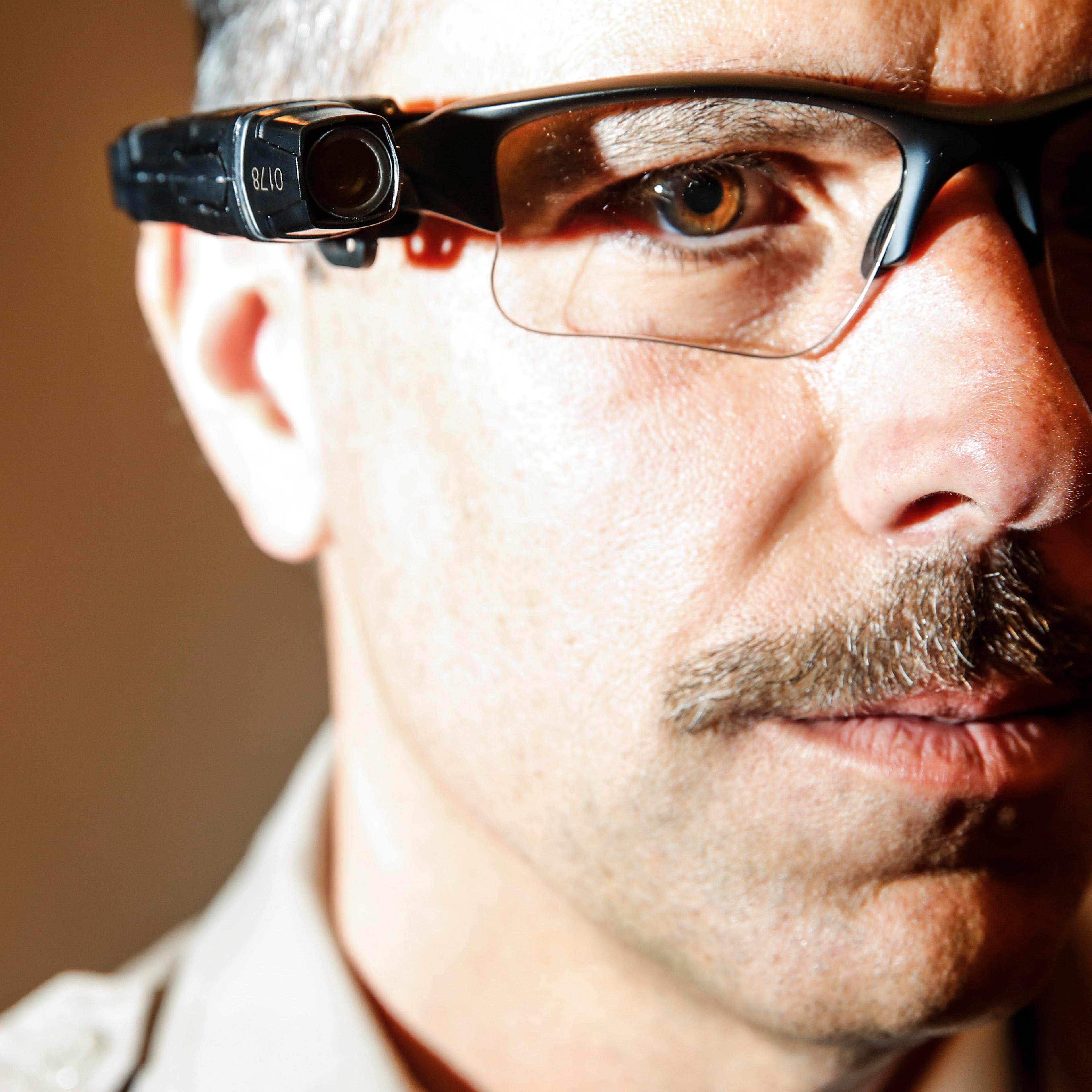 County of Los Angeles Sheriff's Lt. Chris Marks poses wearing the Taser Axon Flex, on-officer camera system attached to glasses in Monterey Park on Sept. 17, 2014.