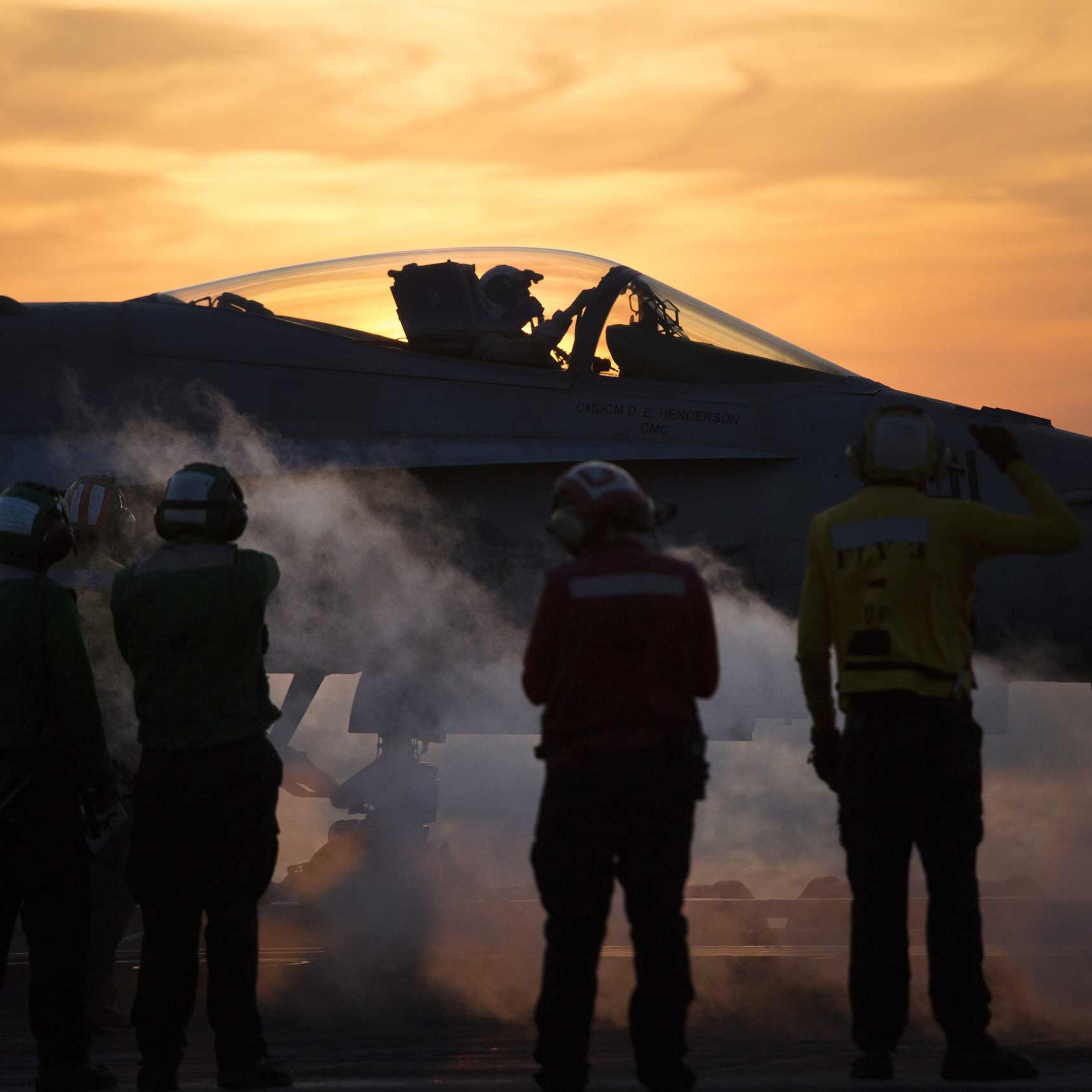 Crew members around an aircraft aboard the USS Carl Vinson, a Nimitz-class aircraft carrier, in the Persian Gulf, Dec. 8, 2014.