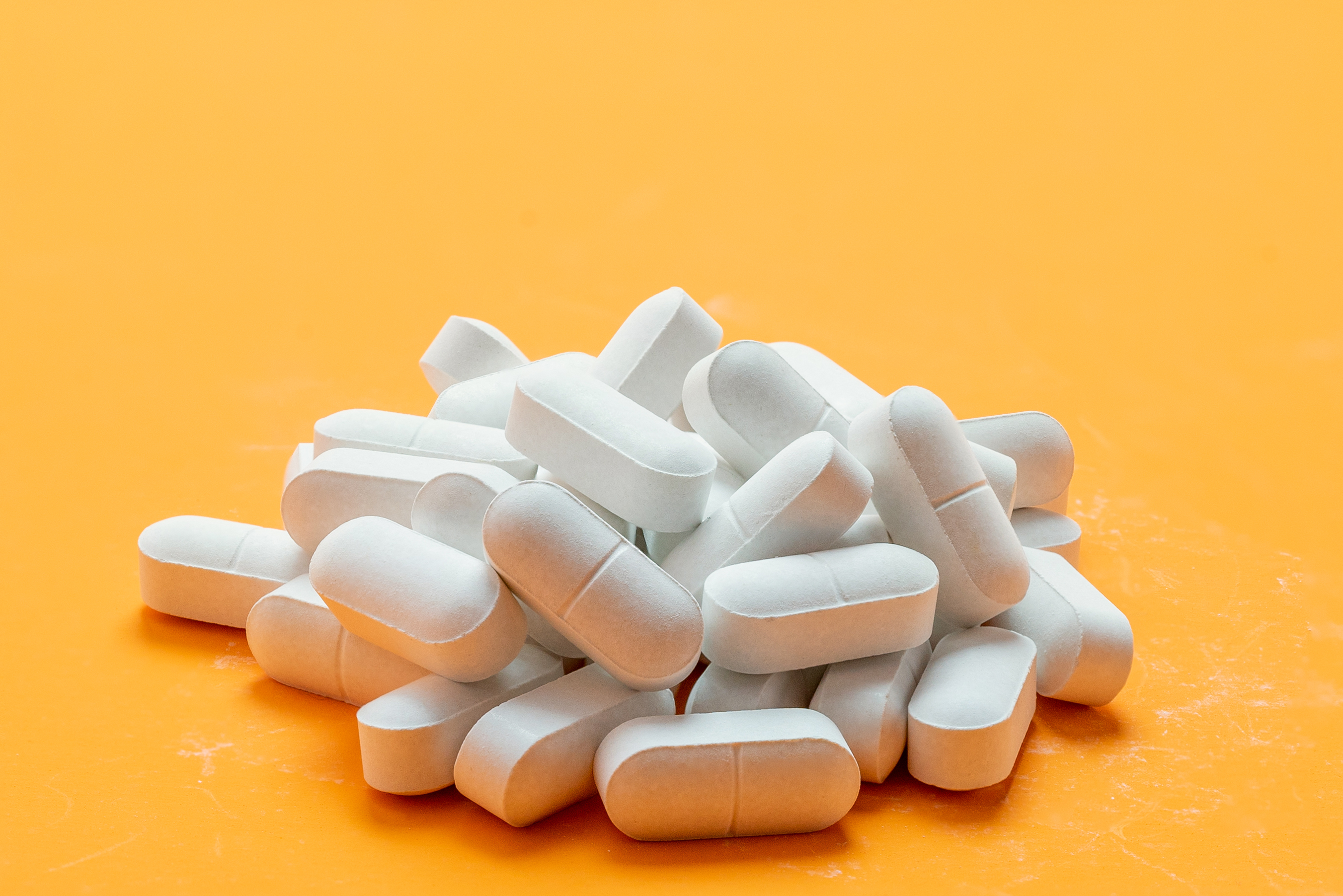 Pills white pigment for on a yellow background