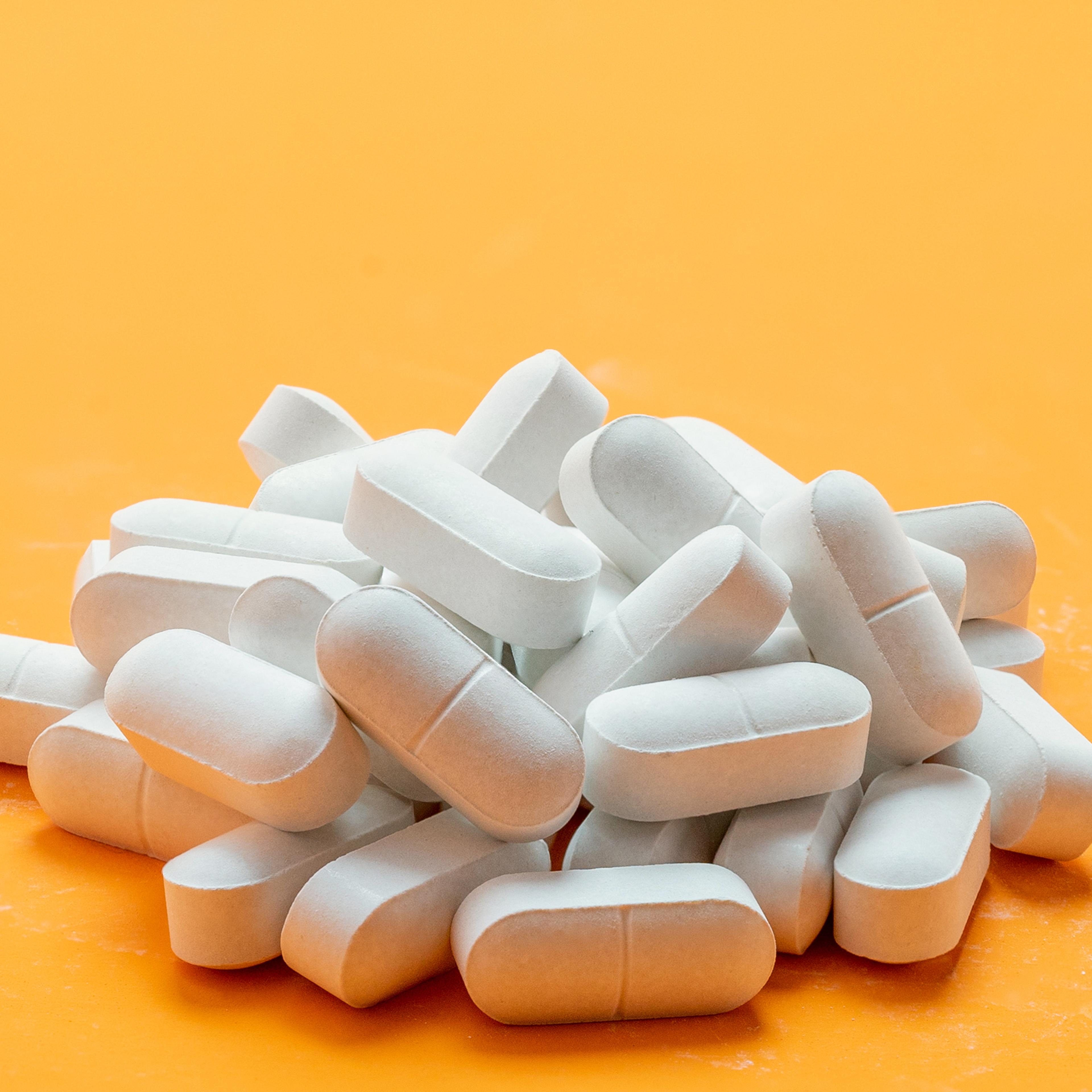 Pills white pigment for on a yellow background