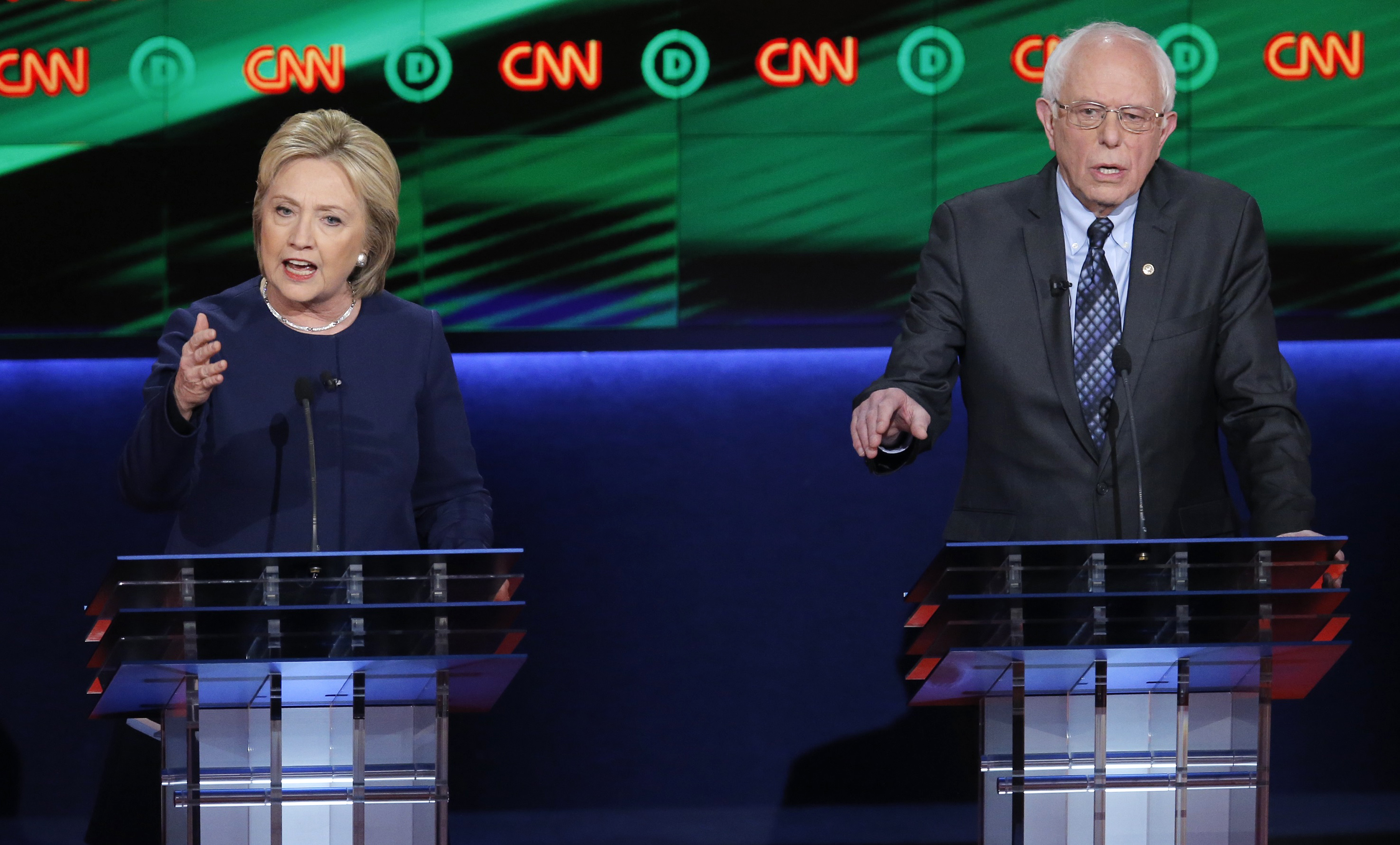 Hillary Clinton and Bernie Sanders speak at the same time during the Democratic U.S. presidential candidates' debate in Flint, MI on March 6, 2016.