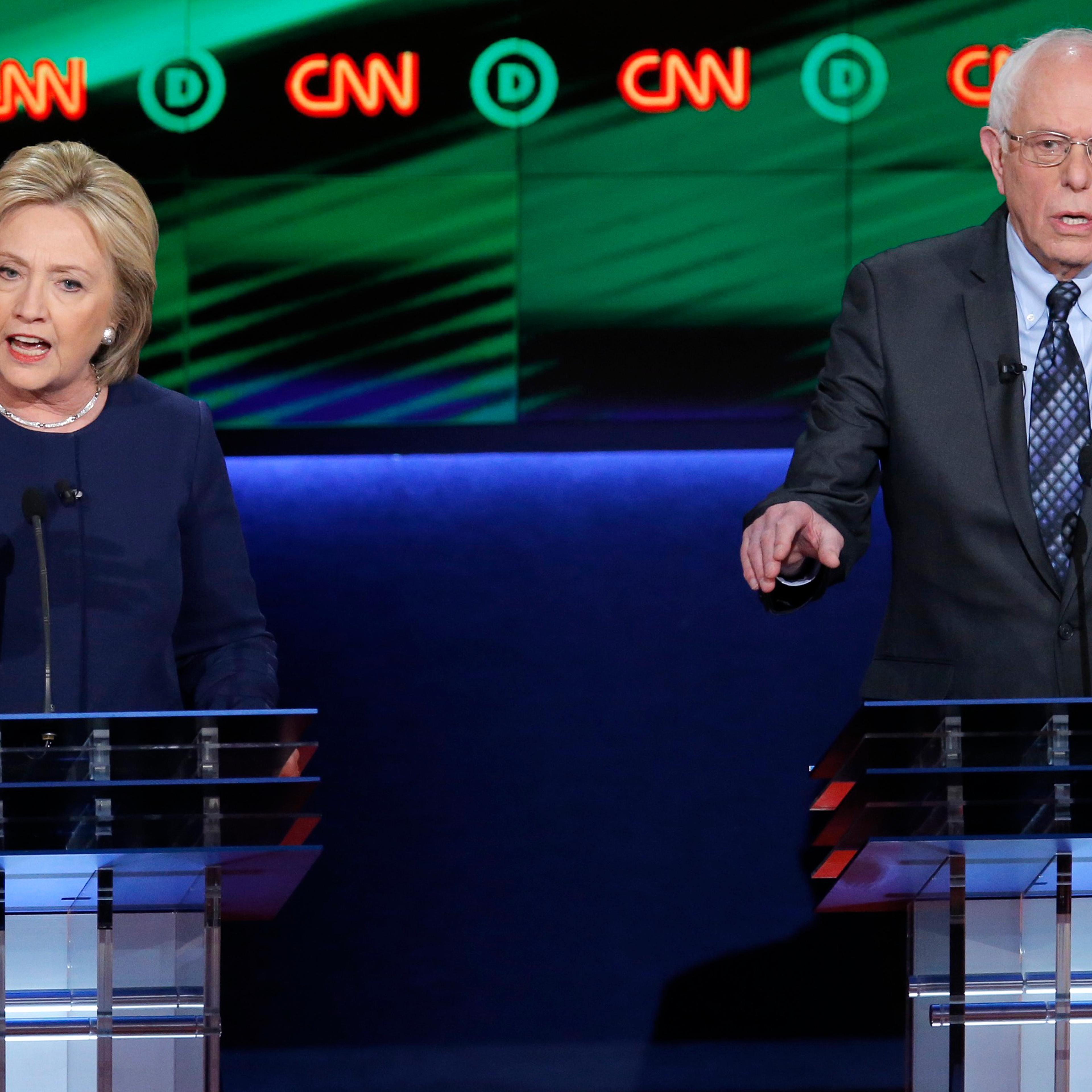 Hillary Clinton and Bernie Sanders speak at the same time during the Democratic U.S. presidential candidates' debate in Flint, MI on March 6, 2016.